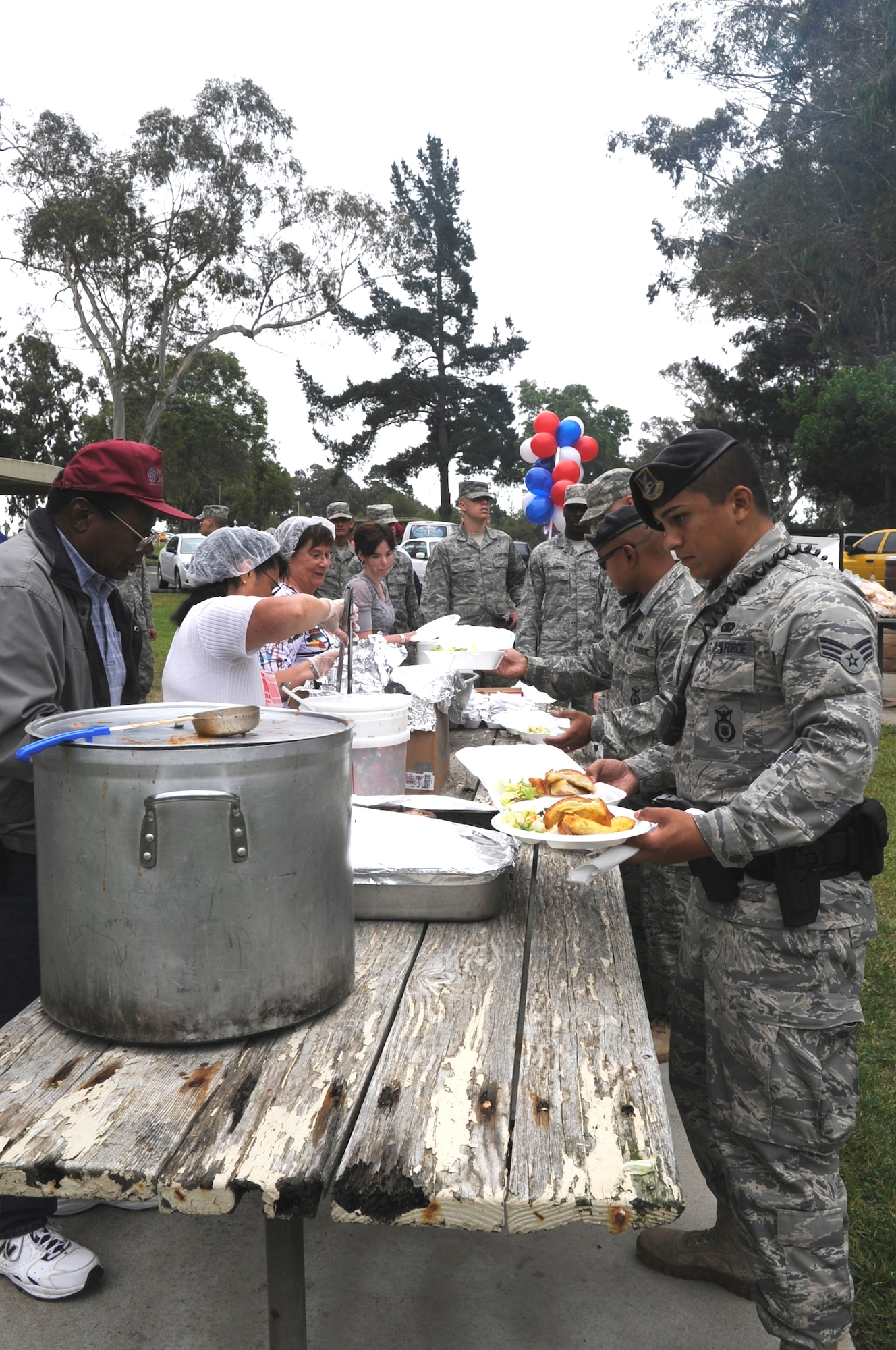 VANDENBERG AIR FORCE BASE, Calif. -- Team Vandenberg members load up their plates at an Airman’s Appreciation Barbecue held at Cocheo Park here Friday, Aug. 12, 2011.  The Lompoc Chamber of Commerce Military Affairs Committee hosts this free barbecue annually to say thank you to the service members at Vandenberg. (U.S. Air Force photo/Jerry E. Clemens, Jr.)
