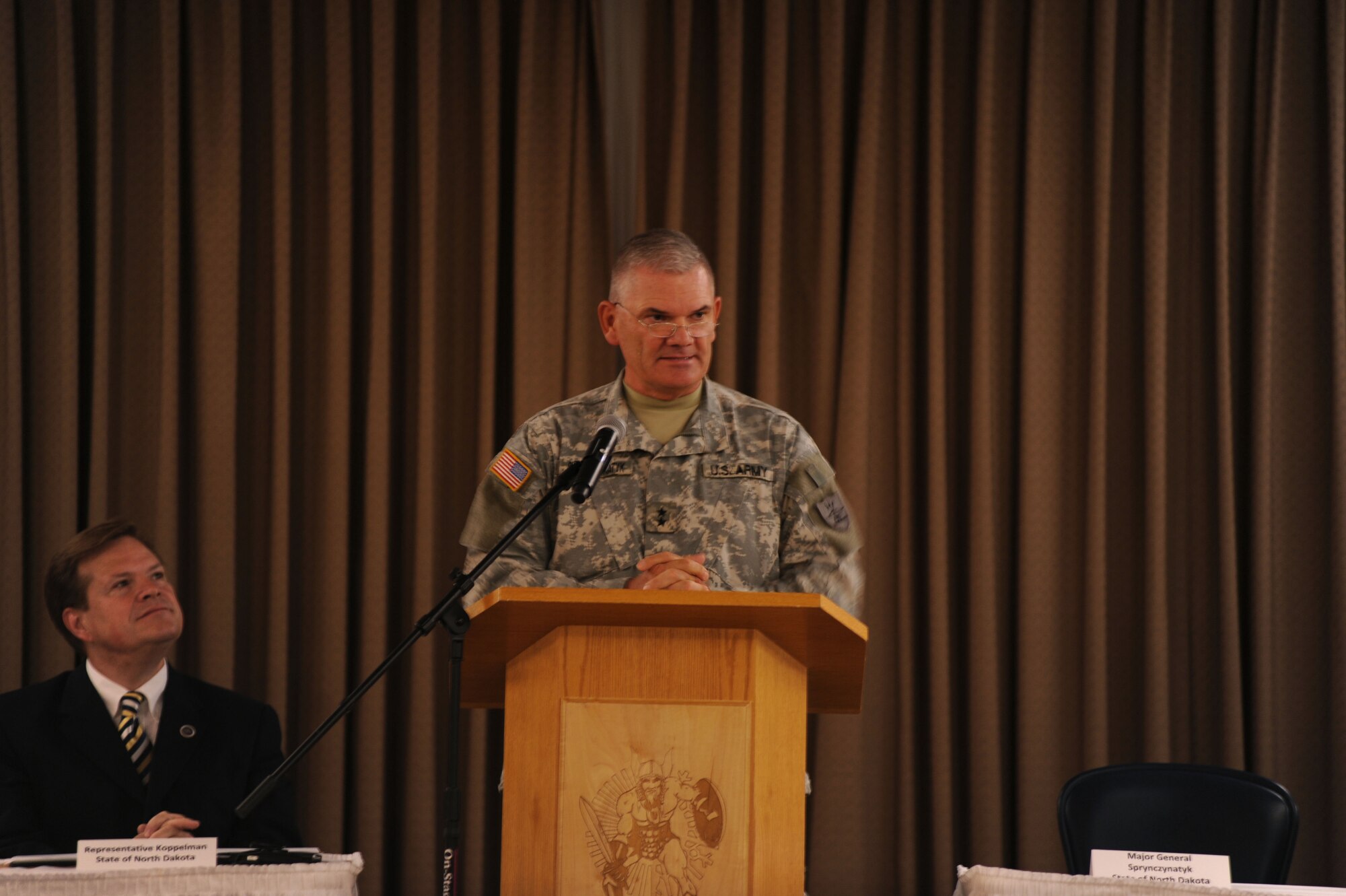 Maj. Gen. David Sprynczynatyk, North Dakota adjutant general, speaks at a conference that marked the beginning of the Interstate Compact on Educational Opportunity for Military Families on Grand Forks Air Force Base Aug 12. This compact eases the transition for children in military families that go from school to school as a result of military mission requirements. (U.S. Air Force photo by Senior Airman Amanda N. Stencil)