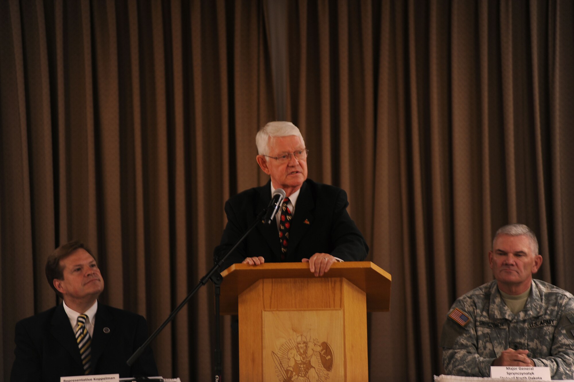 Dr. Wayne Sanstead, chair of the Military Education Council, speaks at a conference that marked the beginning of the Interstate Compact on Educational Opportunity for Military Families on Grand Forks Air Force Base Aug 12. This compact eases the transition for children in military families that go from school to school as a result of military mission requirements. (U.S. Air Force photo by Senior Airman Amanda N. Stencil)