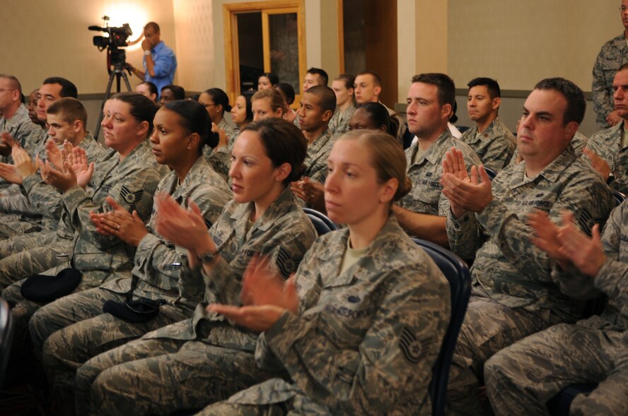 Audience members clap during a conference that marked the beginning of the Interstate Compact on Educational Opportunity for Military Families on Grand Forks Air Force Base Aug 12. This compact eases the transition for children in military families that go from school to school as a result of military mission requirements. (U.S. Air Force photo by Senior Airman Amanda N. Stencil)