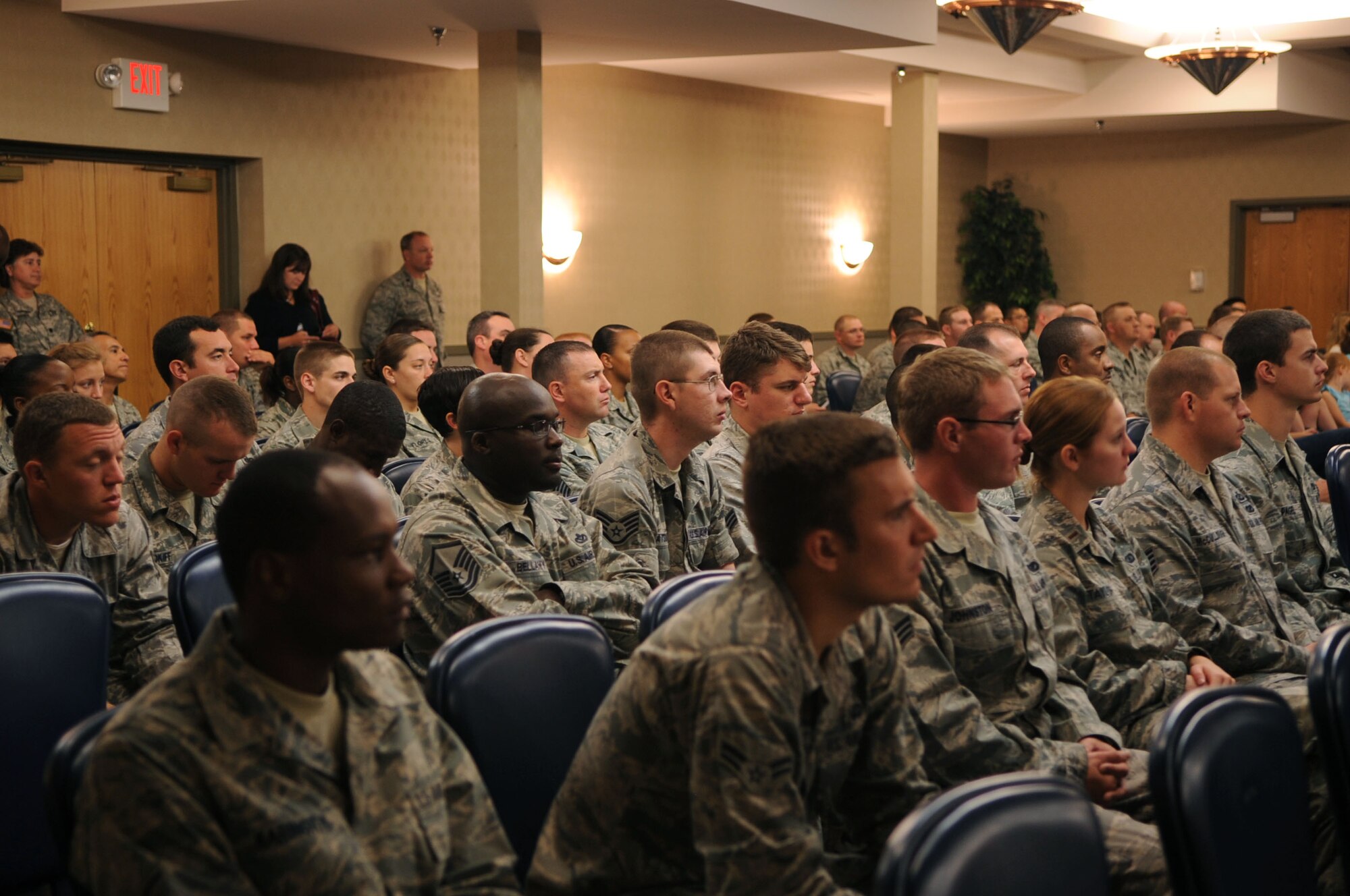 Audience members listen at a conference that marked the beginning of the Interstate Compact on Educational Opportunity for Military Families on Grand Forks Air Force Base Aug 12. This compact eases the transition for children in military families that go from school to school as a result of military mission requirements. (U.S. Air Force photo by Senior Airman Amanda N. Stencil)