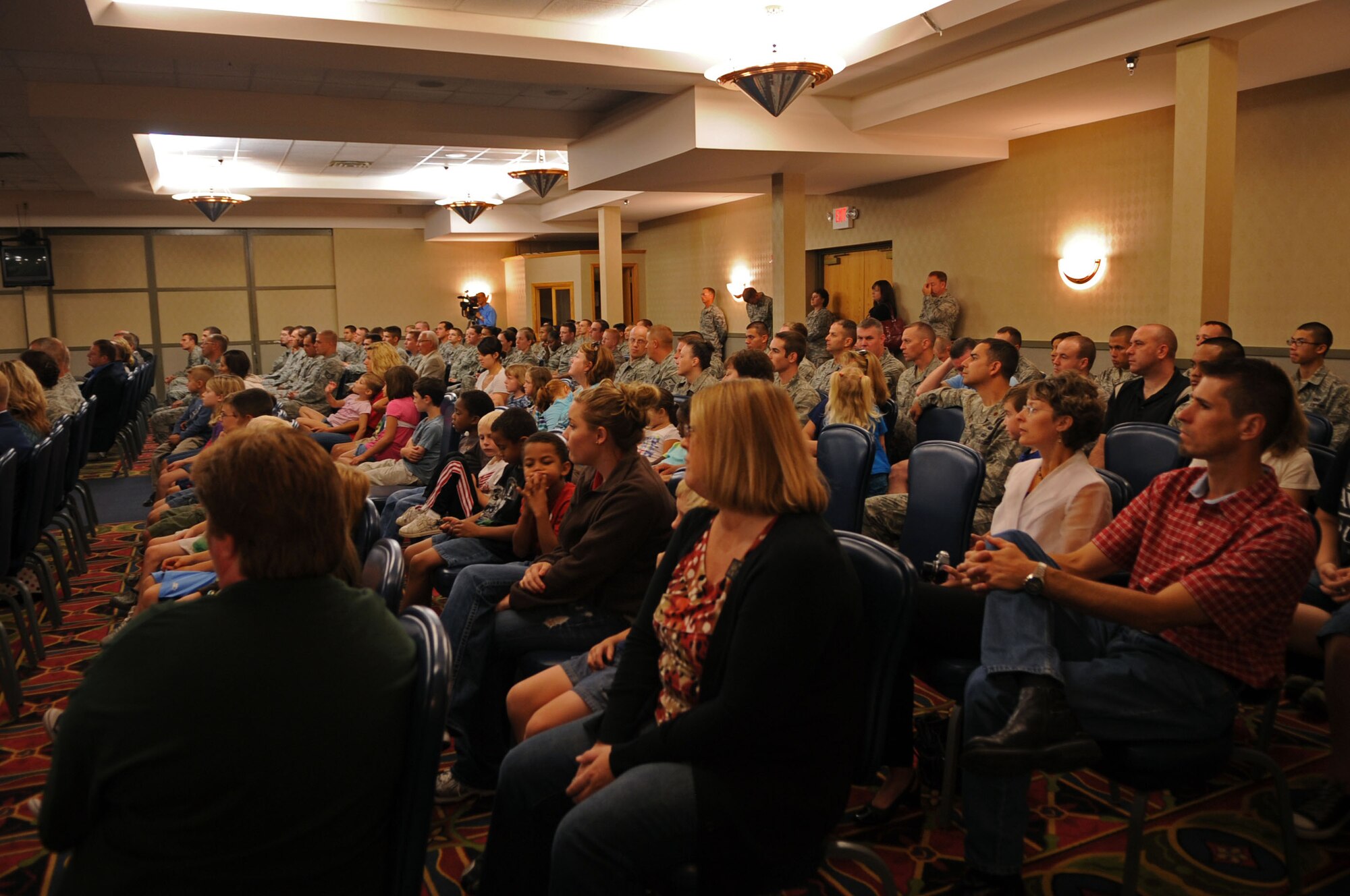 Audience members listen at a conference that marked the beginning of the Interstate Compact on Educational Opportunity for Military Families on Grand Forks Air Force Base Aug 12. This compact eases the transition for children in military families that go from school to school as a result of military mission requirements. (U.S. Air Force photo by Senior Airman Amanda N. Stencil)