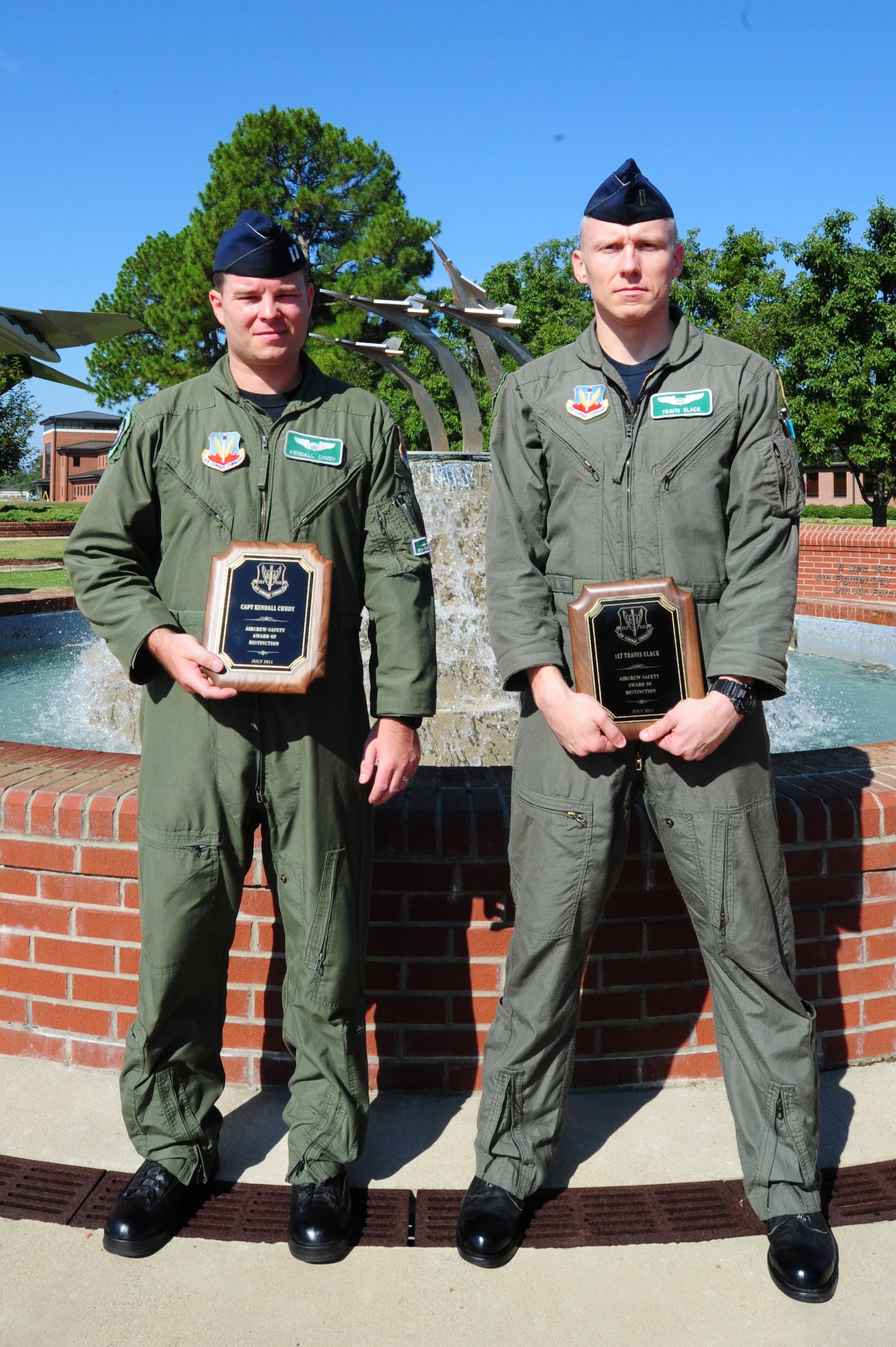 SEYMOUR JOHNSON AIR FORCE BASE, N.C. – Capt. Kendall Chudy and 1st Lt. Travis Slack pose with their 9th Air Force Safety Awards here, August 9, 2011. Chudy and Slack were awarded for actions on May 10, 2011 at the Test and Training Range near Hill Air Force Base, Utah during a large force exercise. Their quick reaction, disciplined trouble shooting and checklist use culminated in the safe return of a $54 million United States Air Force combat asset to Hill and showed the excellent aerial abilities and disciplined airmanship of the 335th Fighter Squadron as well as the 4th Fighter Wing. (U.S. Air Force photo by Senior Airman Rae Perry/RELEASED)