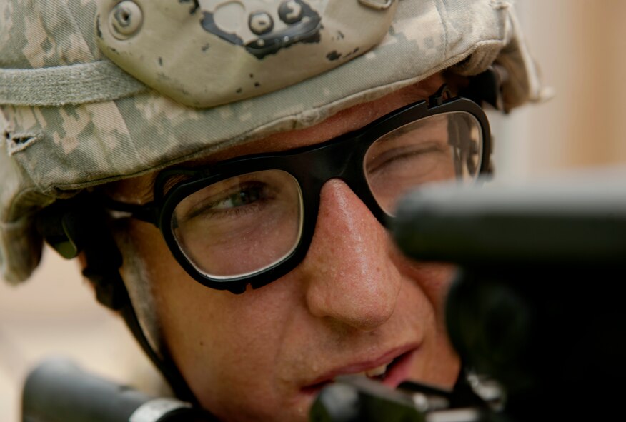 U.S. Air Force 2nd Lt. Luke Fekete, Oklahoma Air Logistics Center Aerospace Sustainment Directorate deployment liaison, from Oklahoma City looks down the barrel of his weapon while clearing buildings at the military operations in urban terrain village training facility during an air liaison officer training course at Moody Air Force Base, Ga., Aug. 4, 2011. During the exercise, trainees were tasked to tactfully and safely clear buildings and find and suppress the enemies attacking the village. (U.S. Air Force photo by Airman 1st Class Joshua Green/Released)
