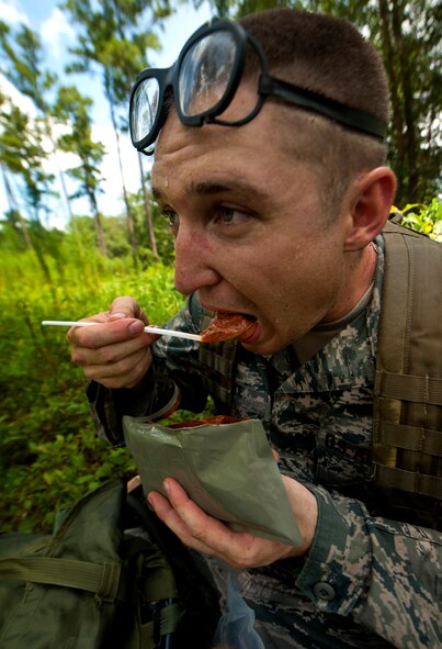 U.S. Air Force 2nd Lt. Luke Fekete, Oklahoma Air Logistics Center Aerospace Sustainment Directorate deployment liaison from Oklahoma City, has a spoonful of sloppy-joe from his Meal, Ready to Eat during an air liaison officer training course at Moody Air Force Base, Ga., Aug. 2, 2011. Trainees were given tasks with specific time limits geared to create a sense of urgency. (U.S. Air Force photo by Airman 1st Class Joshua Green/Released)

