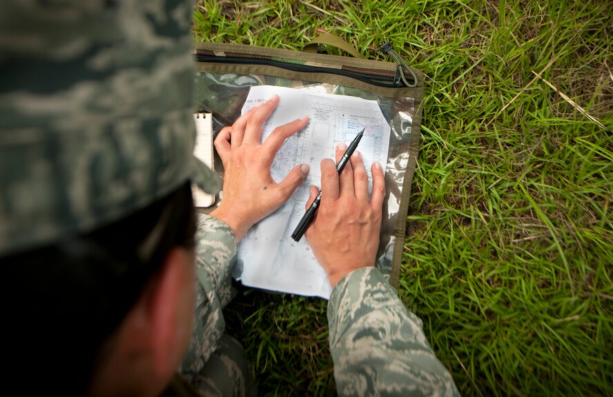 U.S. Air Force 1st Lt. Jessica Terrell, 1st Special Operations Maintenance Squadron munitions accountable systems officer from Hurlburt Field, Fla., calculates a route to take using a map and military-square protractor during a land navigation exercise for the air liaison officer training course at Moody Air Force Base, Ga., Aug. 2, 2011. The military protractor contains two scales with a printed formula and diagram to align map grids. (U.S. Air Force photo by Airman 1st Class Joshua Green/Released)
