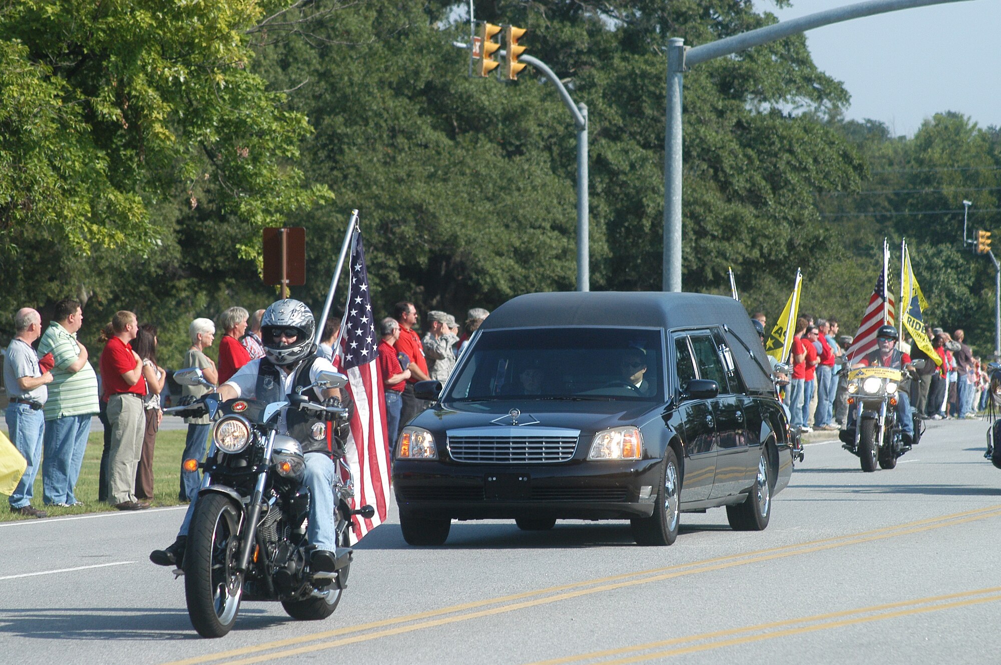 Members of Team Robins line Robins Parkway to pay their respects to Army Specialist Mark Downer, who was killed Aug. 5 while supporting combat operations inAfghanistan. Downer served in the 116th OSS here before transferring to the U.S. Army. He was a combat medic with the 1st Battalion, 32nd Infantry Regiment, 3rd Brigade Combat Team, 10th Mountain Division.  He deployed with his unit to Afghanistan in March. U. S. Air Force photo by Sue Sapp