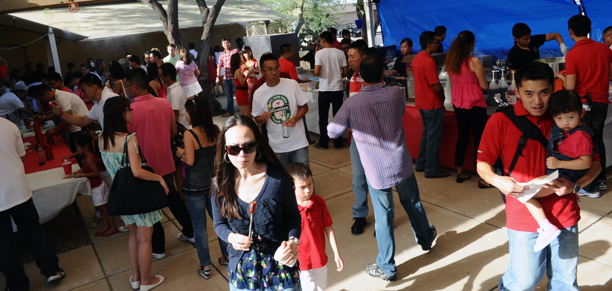 Members of the 425th Fighter Squadron, along with their friends and families, enjoy food and games during the Singapore National Day parade at Club Five Six Aug. 5. (U.S. Air Force photo by Senior Airman Tracie Forte)