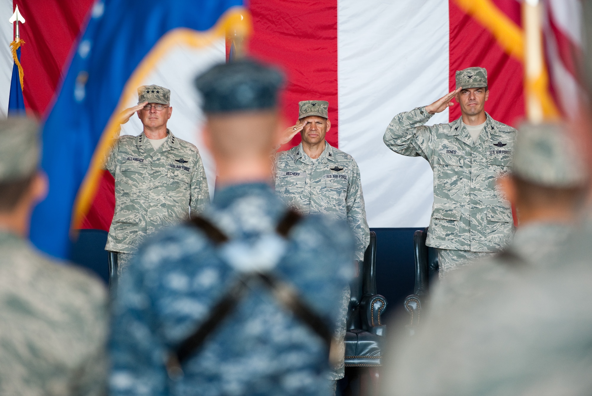 Lt. Gen. Allardice, Col. James Vechery and Col. Dwight Sones salute the colors, presented by the honor gurad, Aug. 5 during the 60th AMW change of command ceremony. During the ceremony, Sones assumed command of the wing from Allardice. (U.S. Air Force photo/Ken Wright)