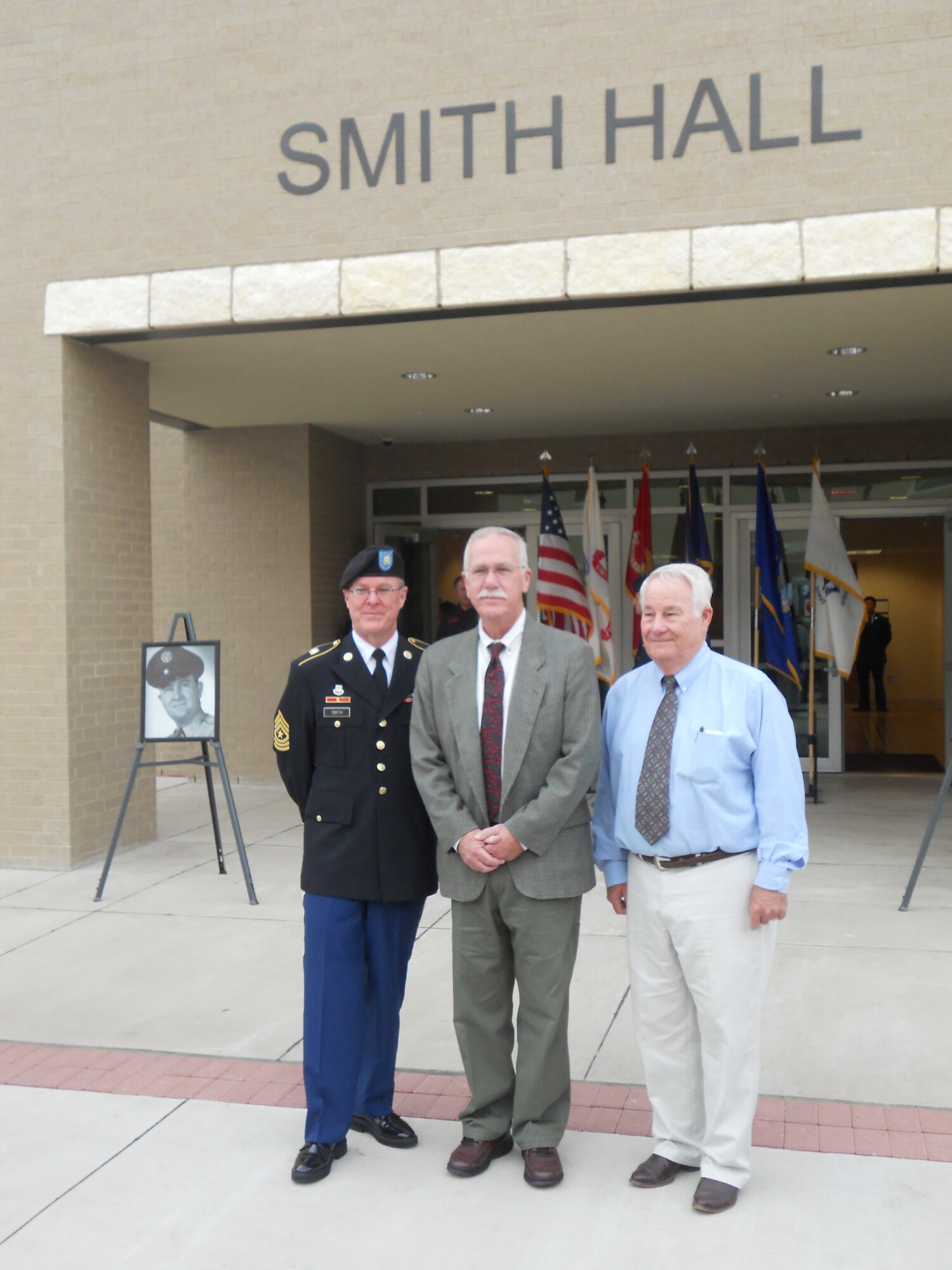 Army Sergeant Major Dan Smith, along with brothers Bob and Jerry Smith, stand in front of the METC facility, Smith Hall, during the dedication ceremony on Aug. 12, 2011 at Fort Sam Houston, to honor their father, the late Chief Master Sergeant Raymond T. Smith, the nation’s first Sergeant Major for the United States Air Force Medical Service. (U.S. Air Force photo/Jon Stock)