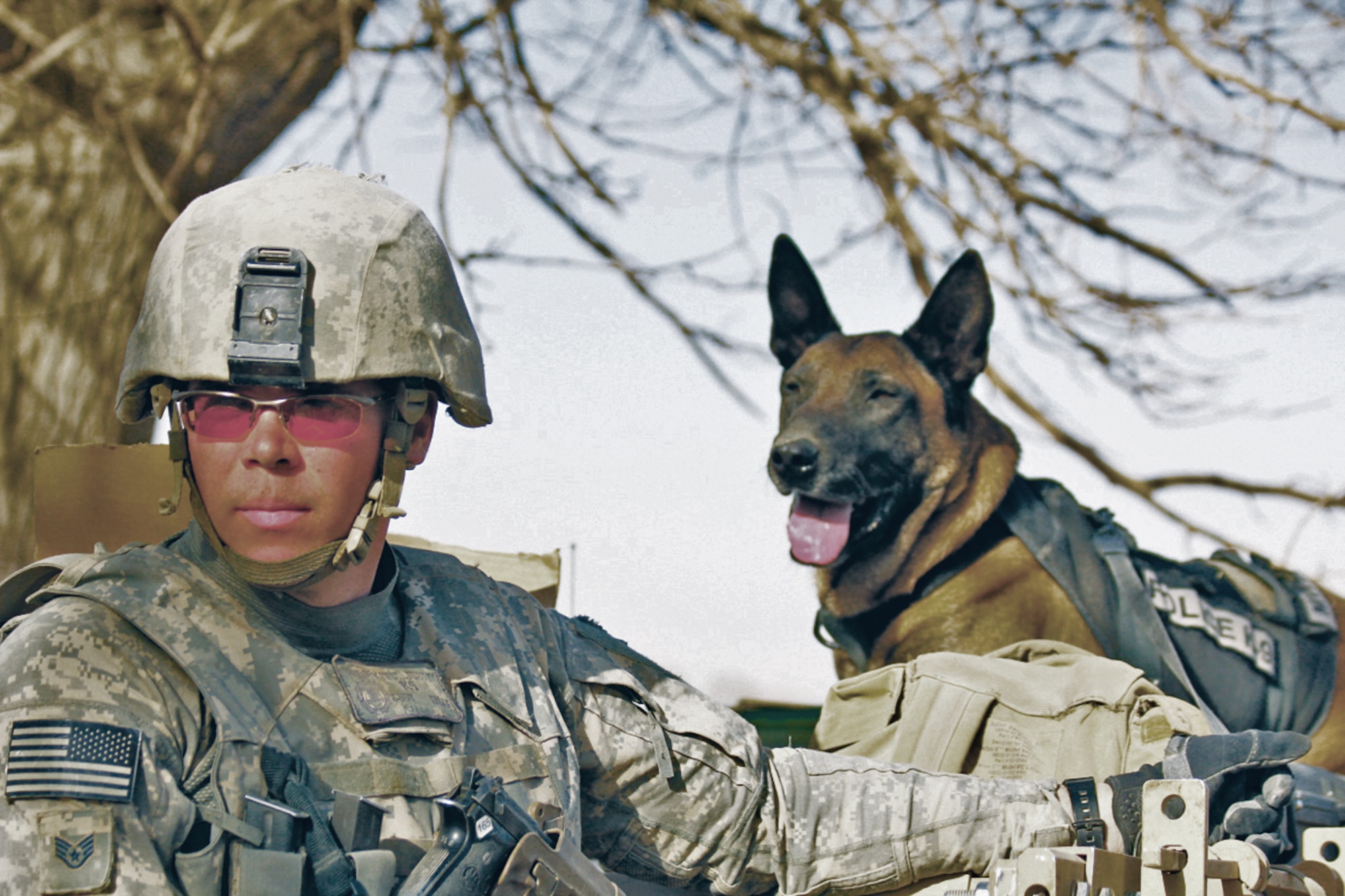 Staff Sgt. Justin Kitts, 56th Security Forces Squadron military working dog handler, and Dyngo, 56th SFS MWD, pose for a photo while on foot patrol during their deployment in Afghanistan.  (Courtesy photo)