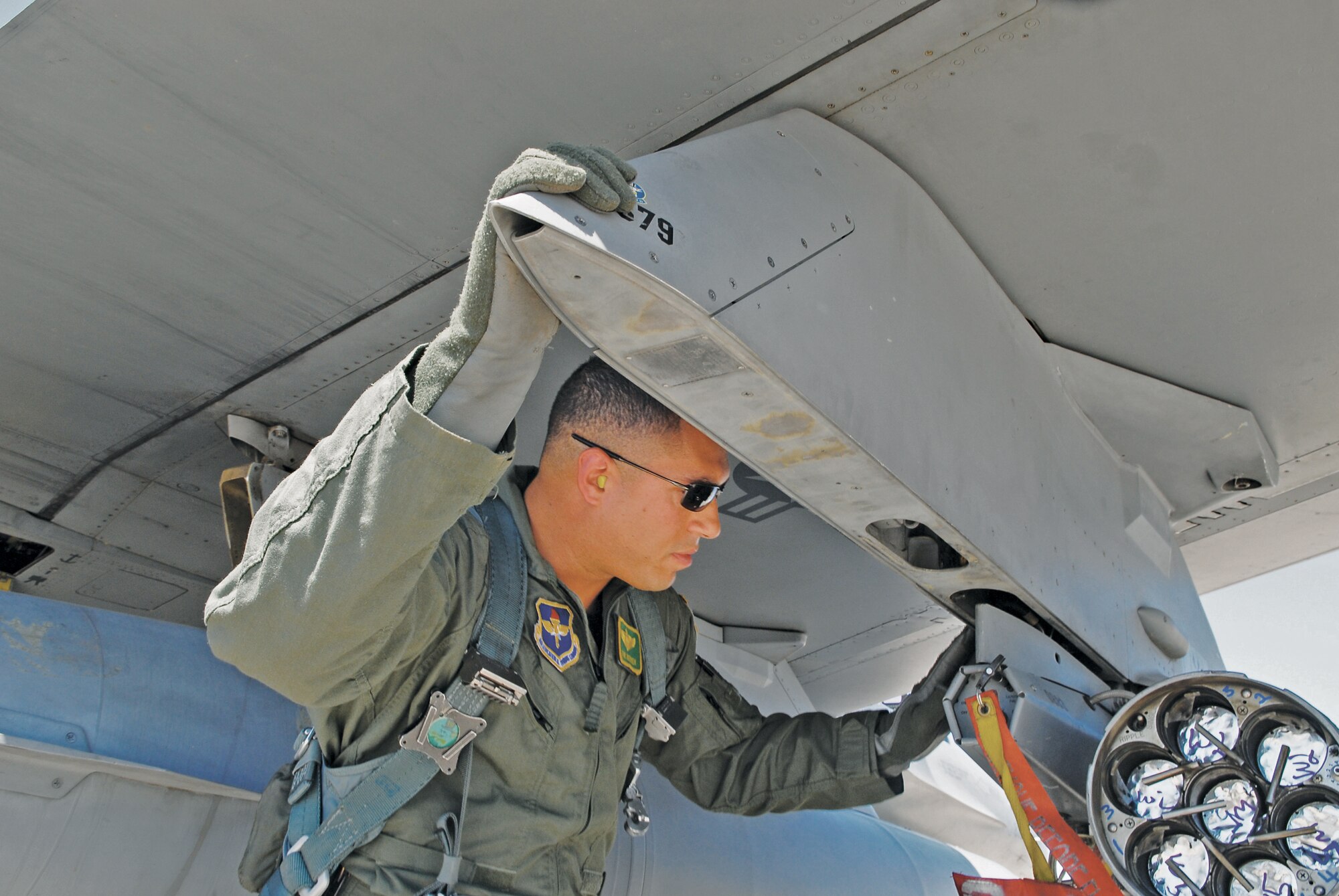 Maj. Tom Juntunen, 310th Fighter Squadron instructor pilot with more than 1,500 flying hours in the F-16 Fighting Falcon, conducts a preflight inspection before taking off to participate in a close air support exercise Aug. 2 at Luke Air Force Base.  Juntunen's job is to certify a select number of F-16 pilots to be controllers in the sky.  With their training at Luke behind them, forward air controllers (airborne) or FAC(A)s prioritize battlefield targets and act as gatekeepers for U.S. Army commanders on the ground.  (U.S. Air Force photo by Senior Master Sgt. Larry Schneck)