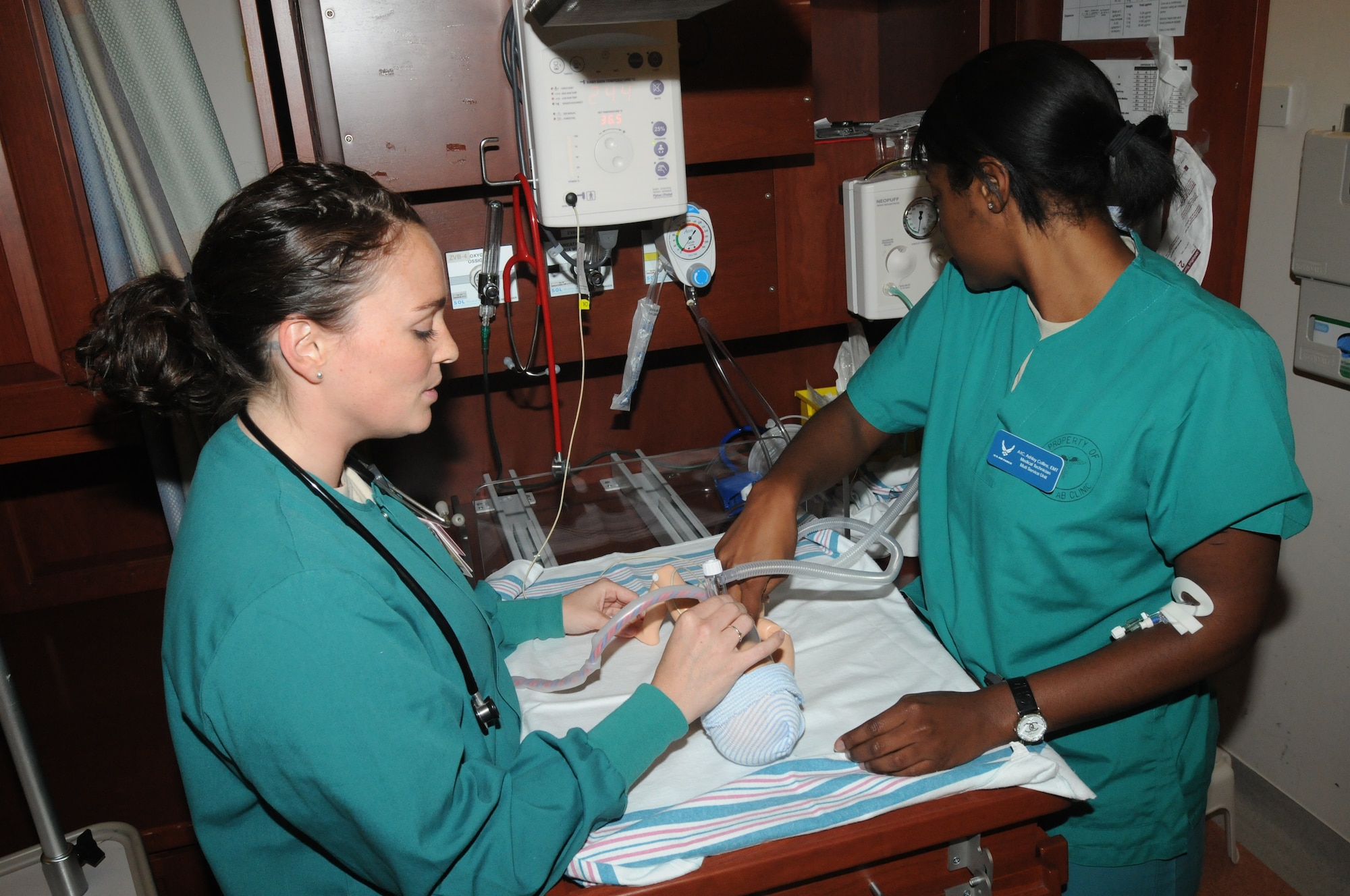Capt. Danielle Merritt, 31st Surgical Operations Squadron clinical nurse, instructs Airman 1st Class Ashley Collins on emergency training for the resuscitation of newborns Aug. 8 at the 31st Medical Group Hospital at Aviano Air Base, Italy. Merritt trains Collins to prepare her for real world emergency situations to improve the quality of care for all patients. (U.S. Air Force photo/Airman LaVel Sterling)