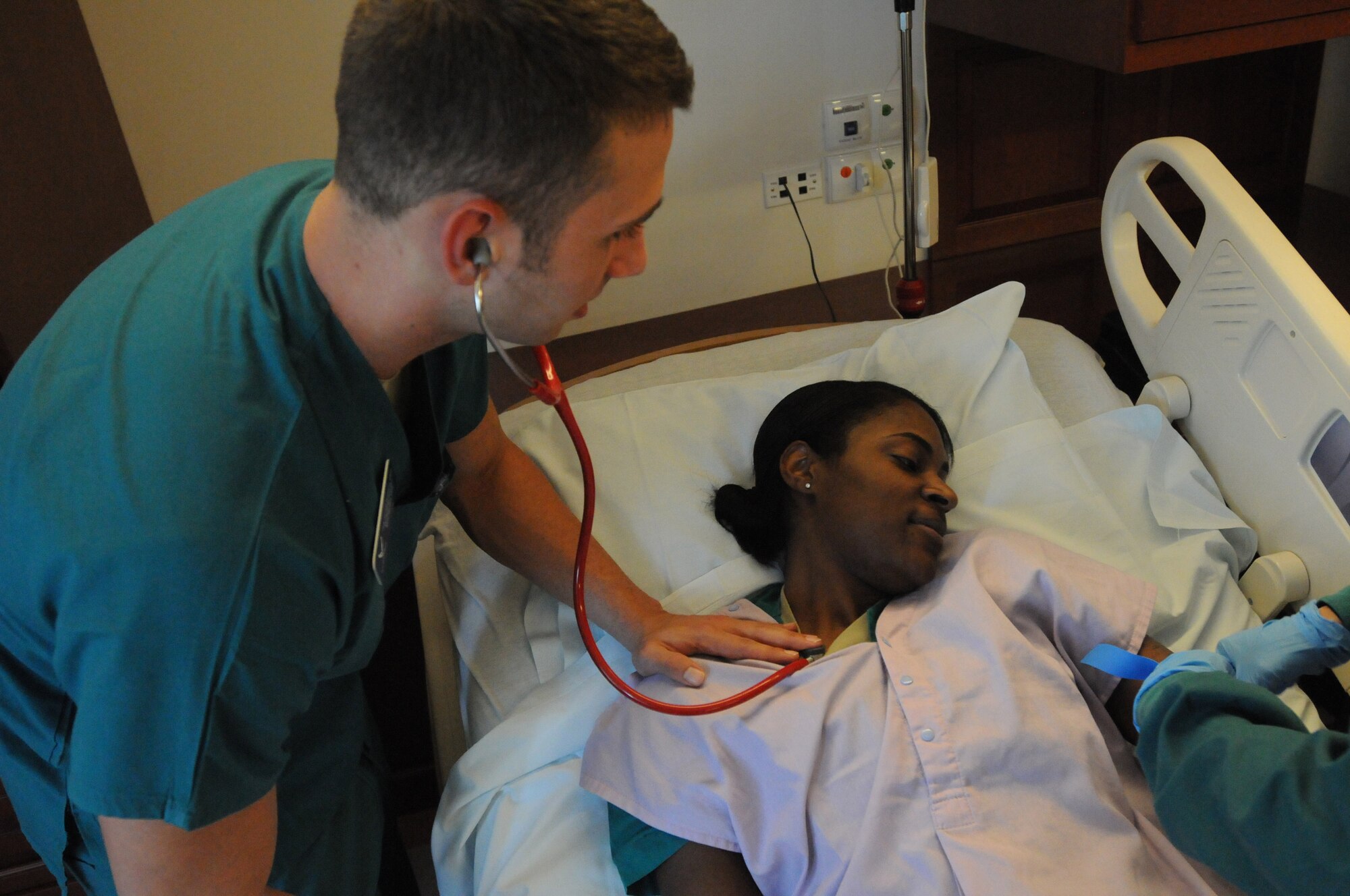 Senior Airman James Wallace, 31st Surgical Operations Squadron aerospace medical technician, uses a stethoscope to obtain the vital signs of Airman 1st Class Ashley Collins, 31st SGC aerospace medical technician, Aug. 8 at the 31st Medical Group hospital.  Wallace and Collins conduct this training as part of a simulated refresher course.(U.S. Air Force photo/Airman LaVel Sterling)