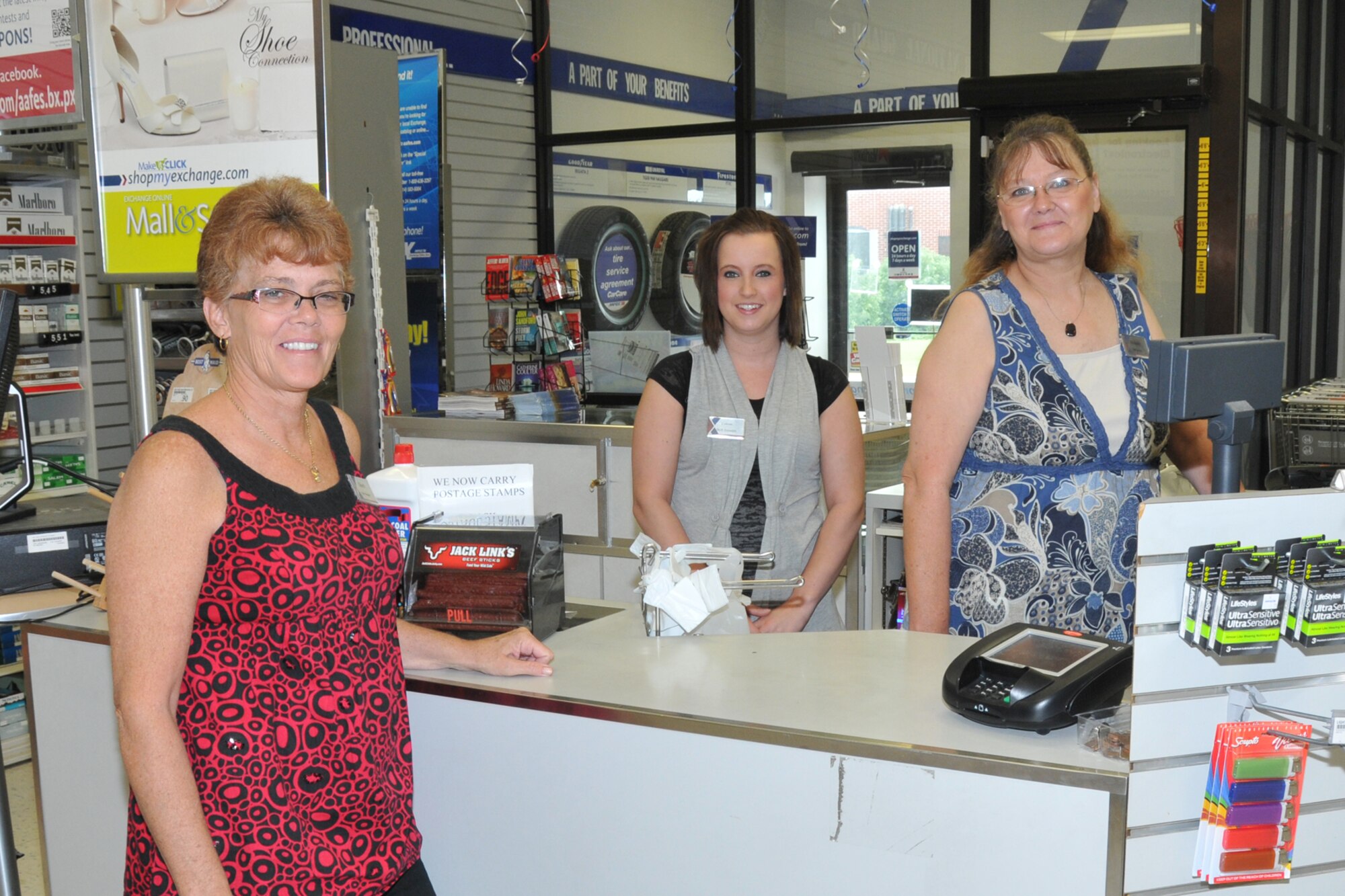 SIOUX FALLS, S.D. - Sherri Oster(left), Joe Foss Field Base Exchange Manager, and Colleen Wilde (center) and Melody Thomas (right), pause for a photo during the Base Exchange 20th Anniversary celebration here August 6, 2011.  Sherri has been with the Base Exchange since it's beginning at Joe Foss Field in 1991. (Photo by Master Sgt. Nancy Ausland)(RELEASED)USAF
