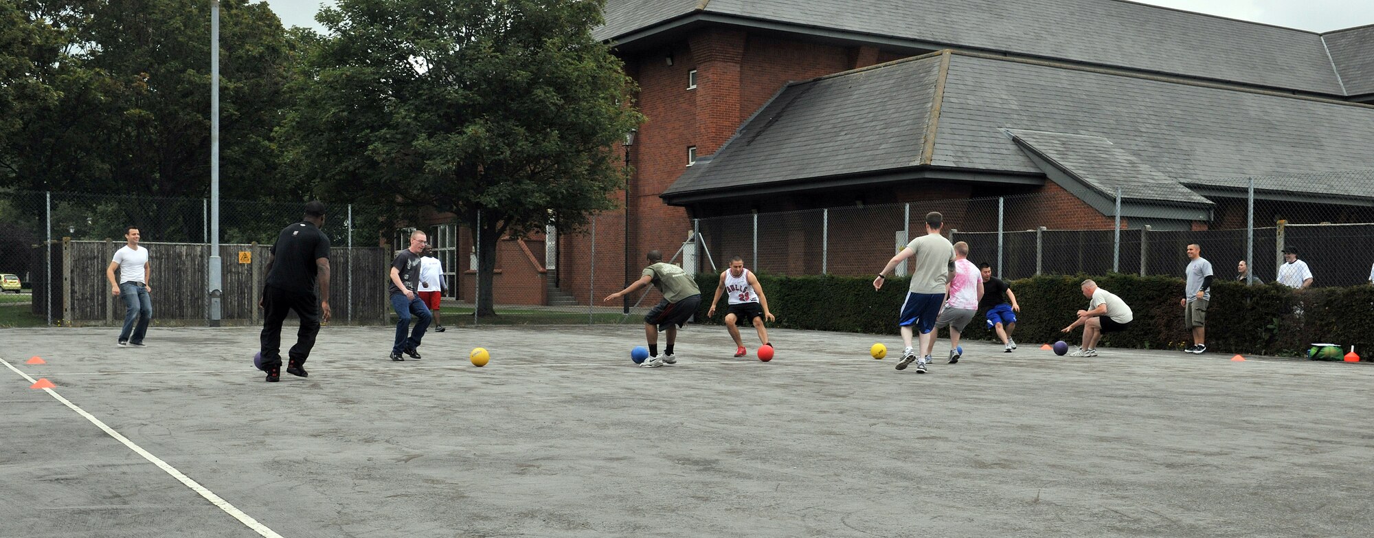 RAF MILDENHALL, England – Airmen compete in a dodgeball tournament here Aug. 12, 2011, during the Unaccompanied Airmen Appreciation Day.  Airmen attending the event were released at noon, leaving their supervisors behind to do all the work while they enjoyed the festivities. (U.S. Air Force photo/Staff Sgt. Tabitha M. Lee)