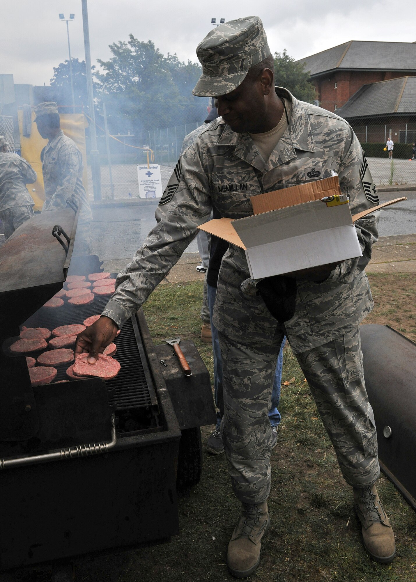 RAF MILDENHALL, England –Chief Master Sgt. Michael McMillan, 352nd Special Operations Support Squadron senior enlisted leader, grills burgers during Unaccompanied Airmen Appreciation Day here Aug. 12, 2011. Airmen were provided free burgers, beverages and live music courtesy of various base organizations. (U.S. Air Force photo/Staff Sgt. Tabitha M. Lee)