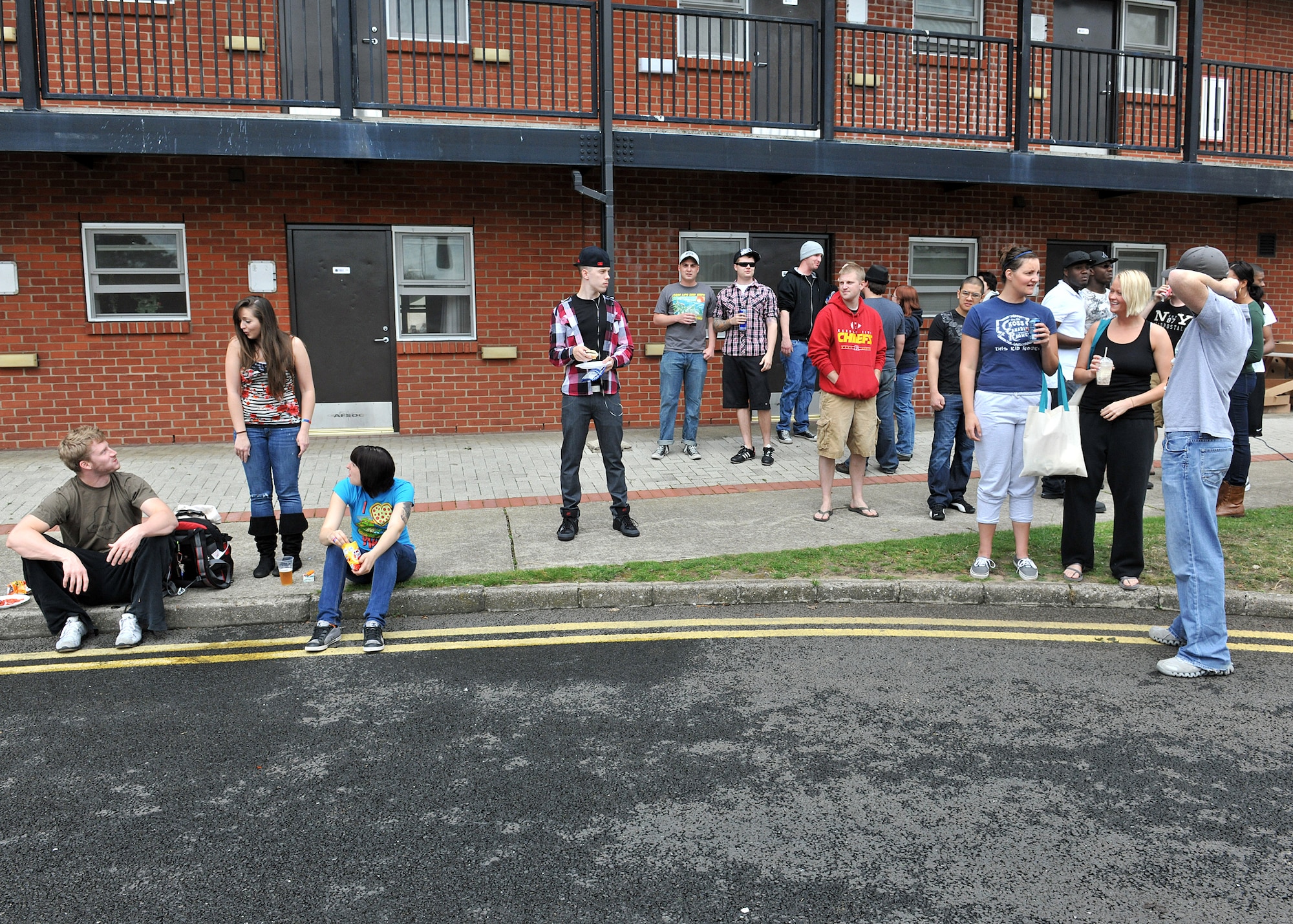 RAF MILDENHALL, England – Airmen hang out during Unaccompanied Airmen Appreciation Day here Aug. 12, 2011.  Airmen were provided free burgers, beverages and live music courtesy of various base organizations. (U.S. Air Force photo/Staff Sgt. Tabitha M. Lee)