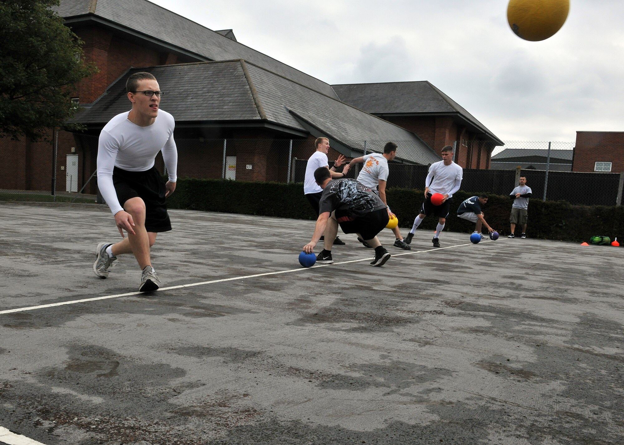 RAF MILDENHALL, England – Airmen compete in a dodgeball tournament here Aug. 12, 2011, during the Unaccompanied Airmen Appreciation Day.  Airmen attending the event were released at noon, leaving their supervisors behind to do all the work, while they enjoyed the festivities. (U.S. Air Force photo/Staff Sgt. Tabitha M. Lee)