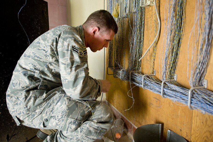 Airman 1st Class Stephen Sovine, 2nd Communications Squadron, traces a phone line on Barksdale Air Force Base, La., Aug. 10. After an office move, a client systems technician must come in and manually reroute each phone line to the new locations. (U.S. Air Force photo/Senior Airman Chad Warren) (RELEASED)