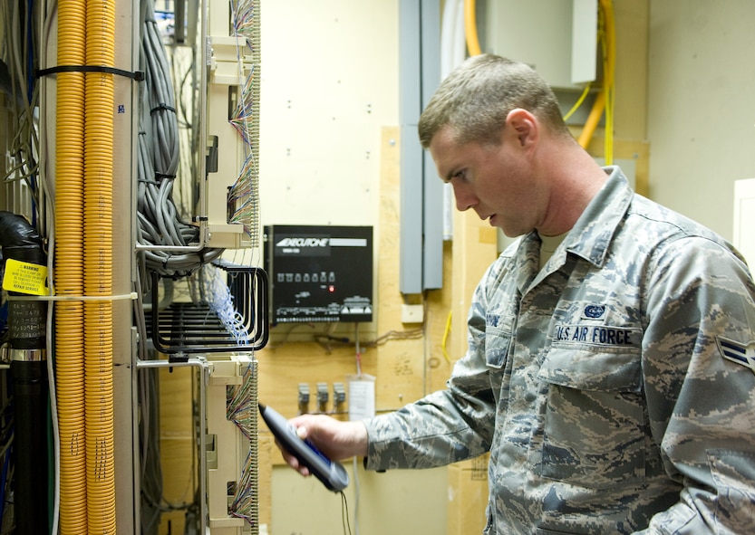 Airman 1st Class Stephen Sovine, 2nd Communications Squadron, checks for an active telephone port on Barksdale Air Force Base, La., Aug. 10. Using an amplifier, Sovine is able to locate which terminal corresponds to each telephone port. (U.S. Air Force photo/Senior Airman Chad Warren)(RELEASED)
