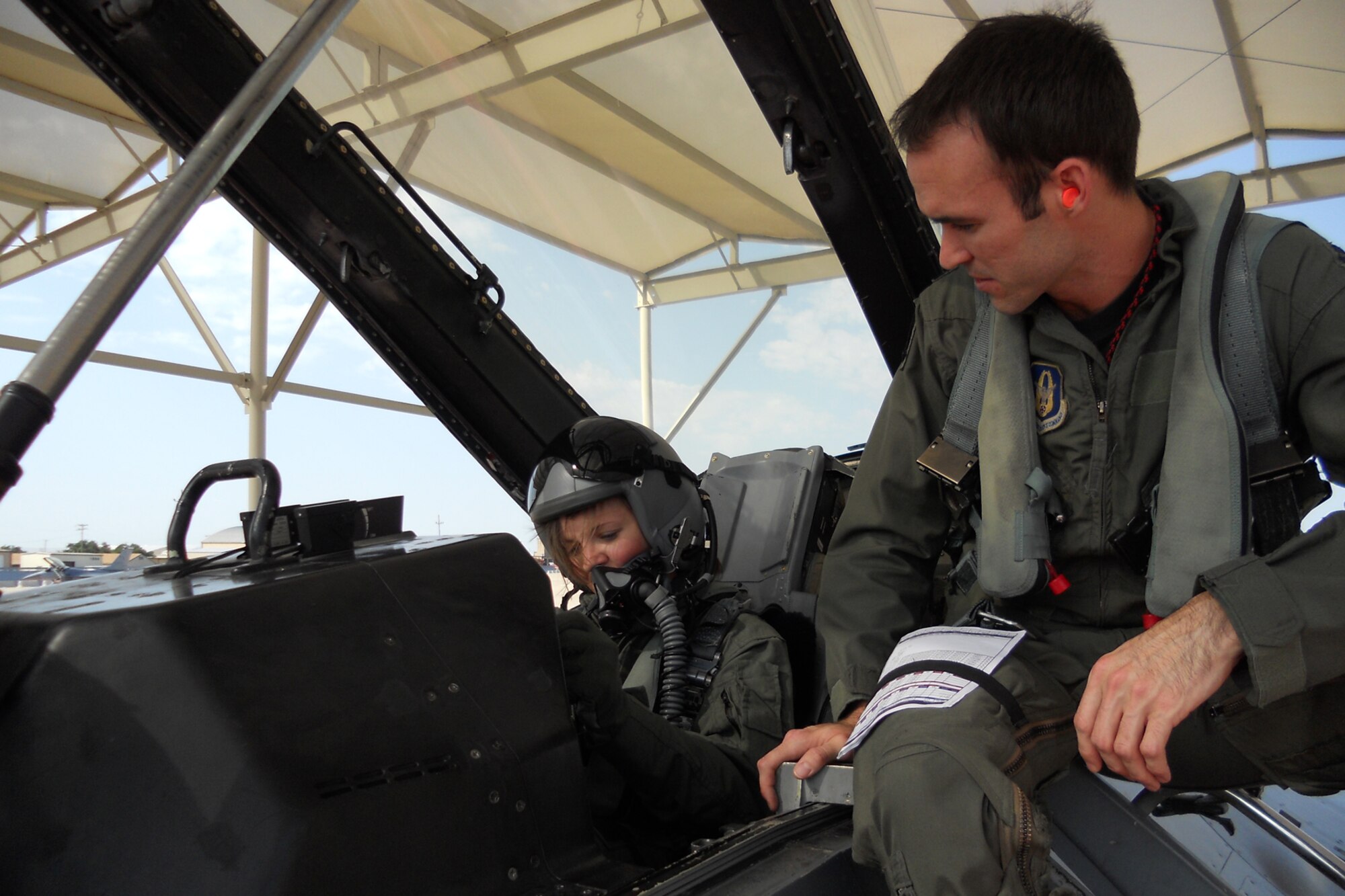 Capt. Christopher Bachelor, a pilot assigned to the 457th Fighter Squadron at Naval Air Station Fort Worth Joint Reserve Base, Texas, makes sure Senior Airman Kimberly Simon, is properly secured in an F-16 Fighting Falcon before her “Incentive Flight,” July 9, 2011. Simon, a flight avionics apprentice assigned to the 917th Aircraft Maintenance Squadron at Barksdale Air Force Base, La., was given the ride for being the 307th Bomb Wing’s Airman of the Year for 2010. (Courtesy photo)