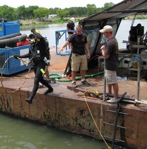 An 86th Engineer Dive Detachment, Special Troops Battalion, 7th Sustainment Brigade diver performs a front step entry into the water. In early June after months of preparation, the 86th mobilized 13 divers and three equipment containers to Fort Smith, Ark., for three weeks in support of the USACE Little Rock District. (Courtesy Photo)