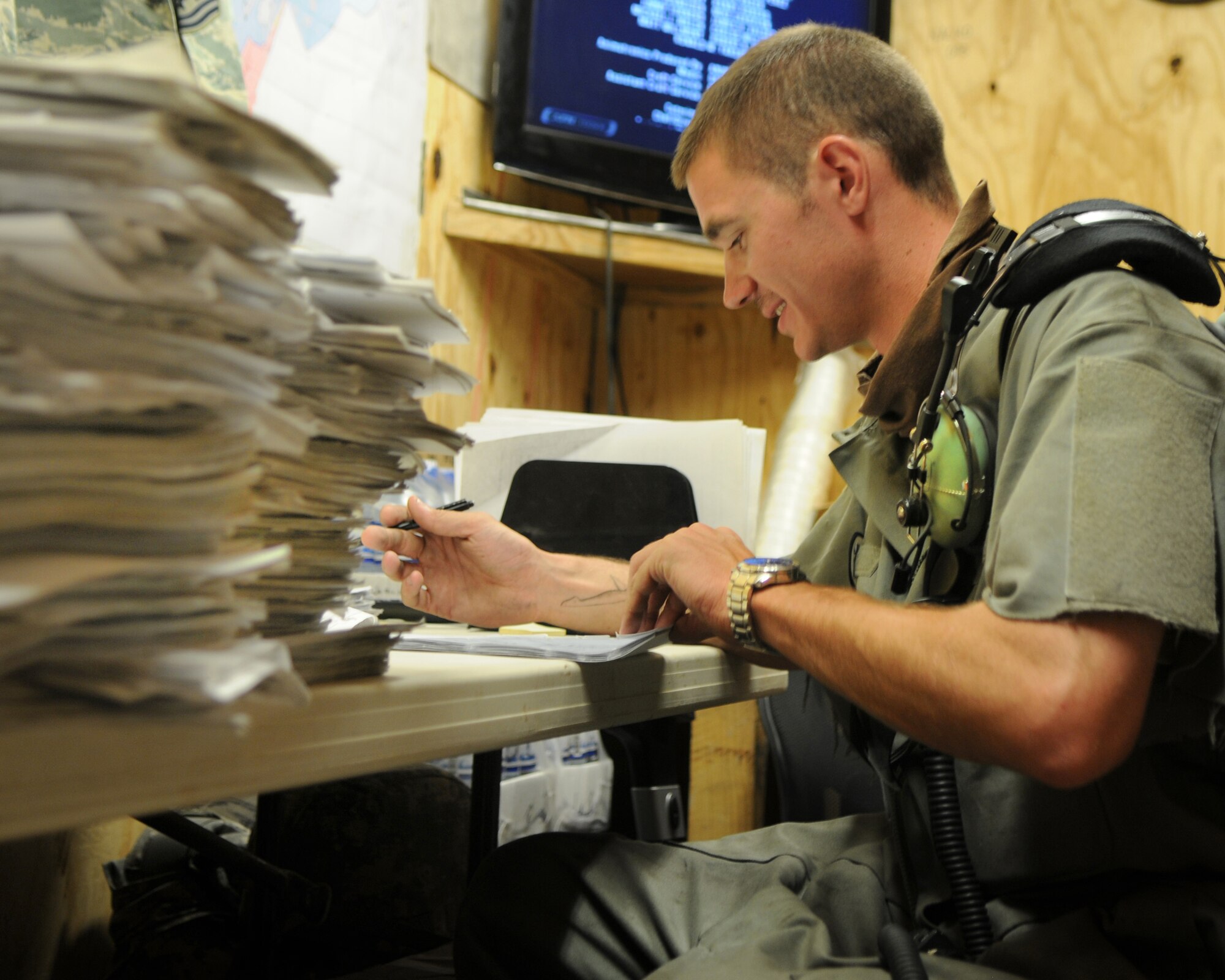 BAGRAM AIRFIELD, Afghanistan -- Staff Sgt. Ezekiel Markham, 455th Expeditionary Aircraft Maintenance Squadron crew chief, reviews aircraft forms here August 11, 2011. Every day, the EAMXS squadron quality checks forms for discrepancies with annotations; if discrepancies are found, it is a no go for the mission. Markham is stationed at Davis-Monthan Air Force Base, Ariz.  (U.S. Air Force photo/Senior Airman Krista Rose)
