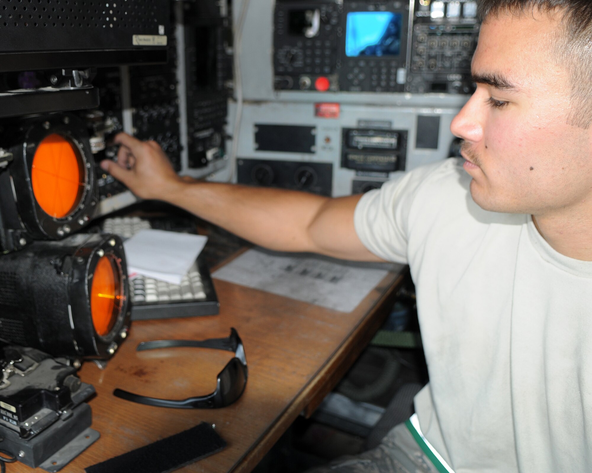 BAGRAM AIRFIELD, Afghanistan -- Senior Airman Thomas Nguyen, 455th Expeditionary Aircraft Maintenance Squadron communications navigation journeyman, performs maintenance on an EC-130 Compass Call aircraft here August 11, 2011. Nguyen, stationed at Davis-Monthan Air Force Base, Ariz., fixed a broken radar scope, preparing it for the next mission. (U.S. Air Force photo/Senior Airman Krista Rose) 