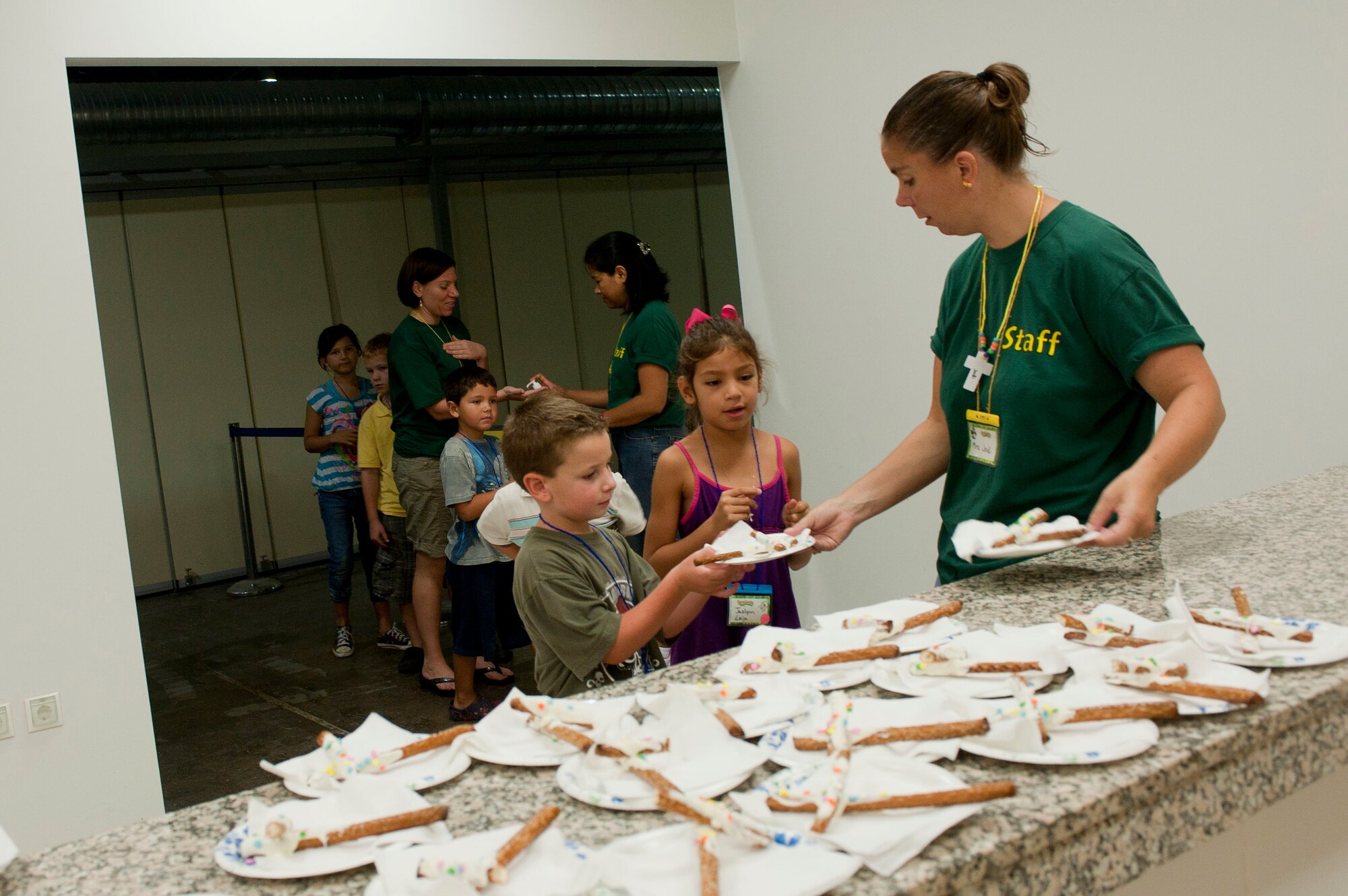 Jodi Ward, PandaMania Vacation Bible School volunteer, hands out snacks to children at VBS Aug. 11, 2011, at Incirlik Air Base, Turkey. VBS was held Aug. 8-12 and is an annual event that provides a fun way for children to reinforce their religious teachings. (U.S. Air Force photo by Airman 1st Class Clayton Lenhardt/Released)