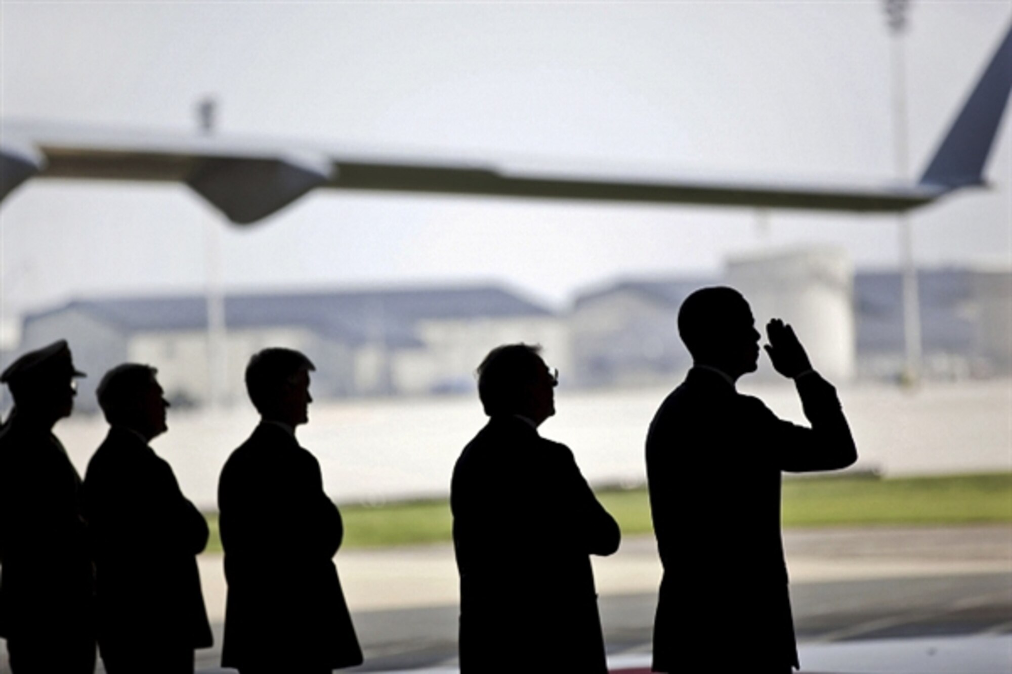 President Barack Obama begins a salute as he participates in a ceremony at Dover Air Force Base in Dover, Del., Aug. 9, 2011, for the dignified transfer of U.S. and Afghan personnel who died in the Aug. 6 helicopter crash in Afghanistan's Wardak province. White House photo by Pete Souza   
