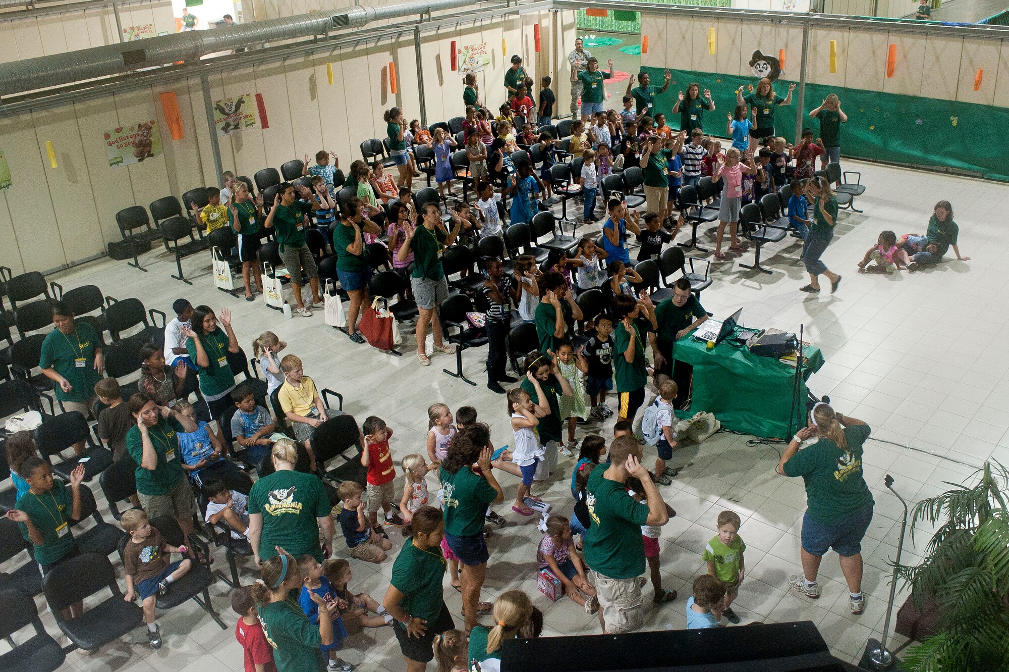 Children and volunteers of PandaMania Vacation Bible School dance and sing along to music Aug. 11, 2011, at Incirlik Air Base, Turkey. VBS was held Aug. 8-12 and is an annual event that provides a fun way for children to reinforce their religious teachings. (U.S. Air Force photo by Airman 1st Class Clayton Lenhardt/Released)