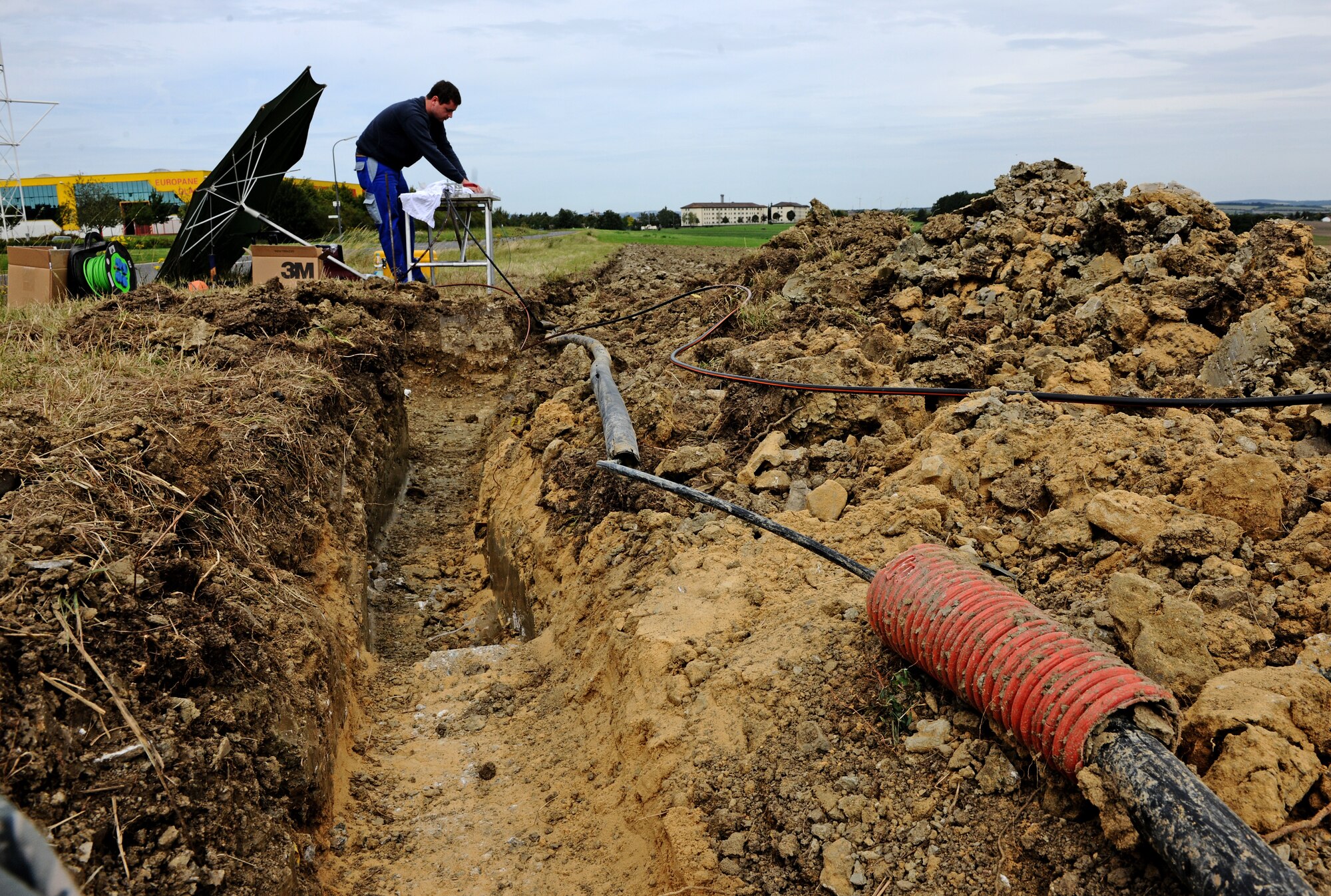BITBURG ANNEX, Germany -- Joerg Thiel, a local contractor, prepares optical fiber cable for splicing here Aug. 11. The 52nd Communications Squadron worked with local contractors to repair a damaged optical fiber line outside Bitburg Annex, which knocked out all the annex’s DSN telephone lines. The cable maintenance technicians repaired the lines after they were inadvertently cut off base Aug. 9. (U.S. Air Force photo/Staff Sgt. Nathanael Callon)