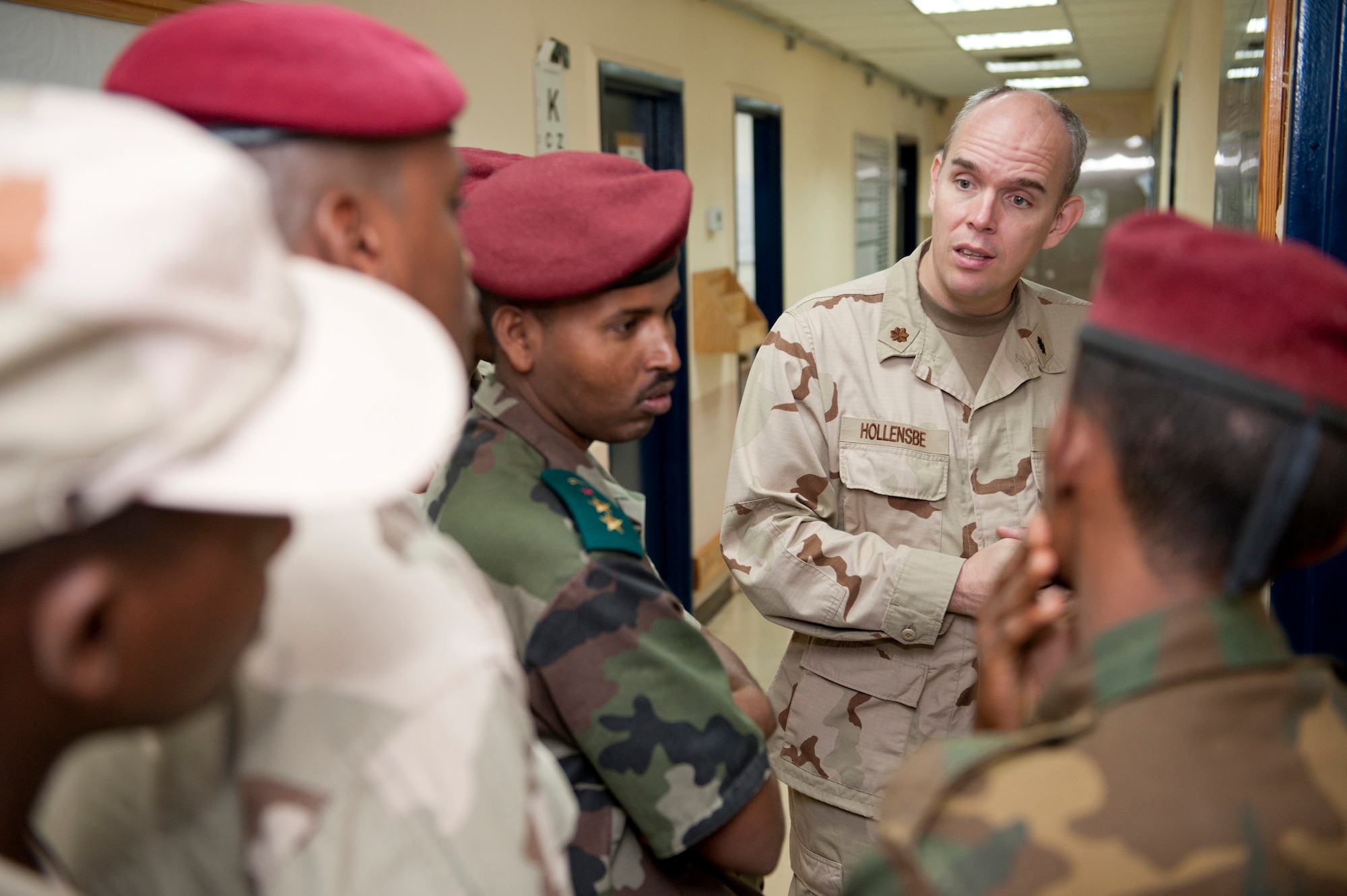 CAMP LEMONNIER, Djibouti -- Lieutenant Commander Jason Hollensbe, Camp Lemonnier Michaud Expeditionary Medical Facility general surgeon, discusses pharmacy practices with servicemembers from the Djiboutian Military Medical Service Corps during a tour of the Expeditionary Medical Facility on Camp Lemonnier, August 9.   Throughout the tour, the Djiboutians were able to see how the U.S. military develops and maintains a fully functioning medical facility with limited space. (U.S. Air Force photo by Staff Sgt. Marc I. Lane)