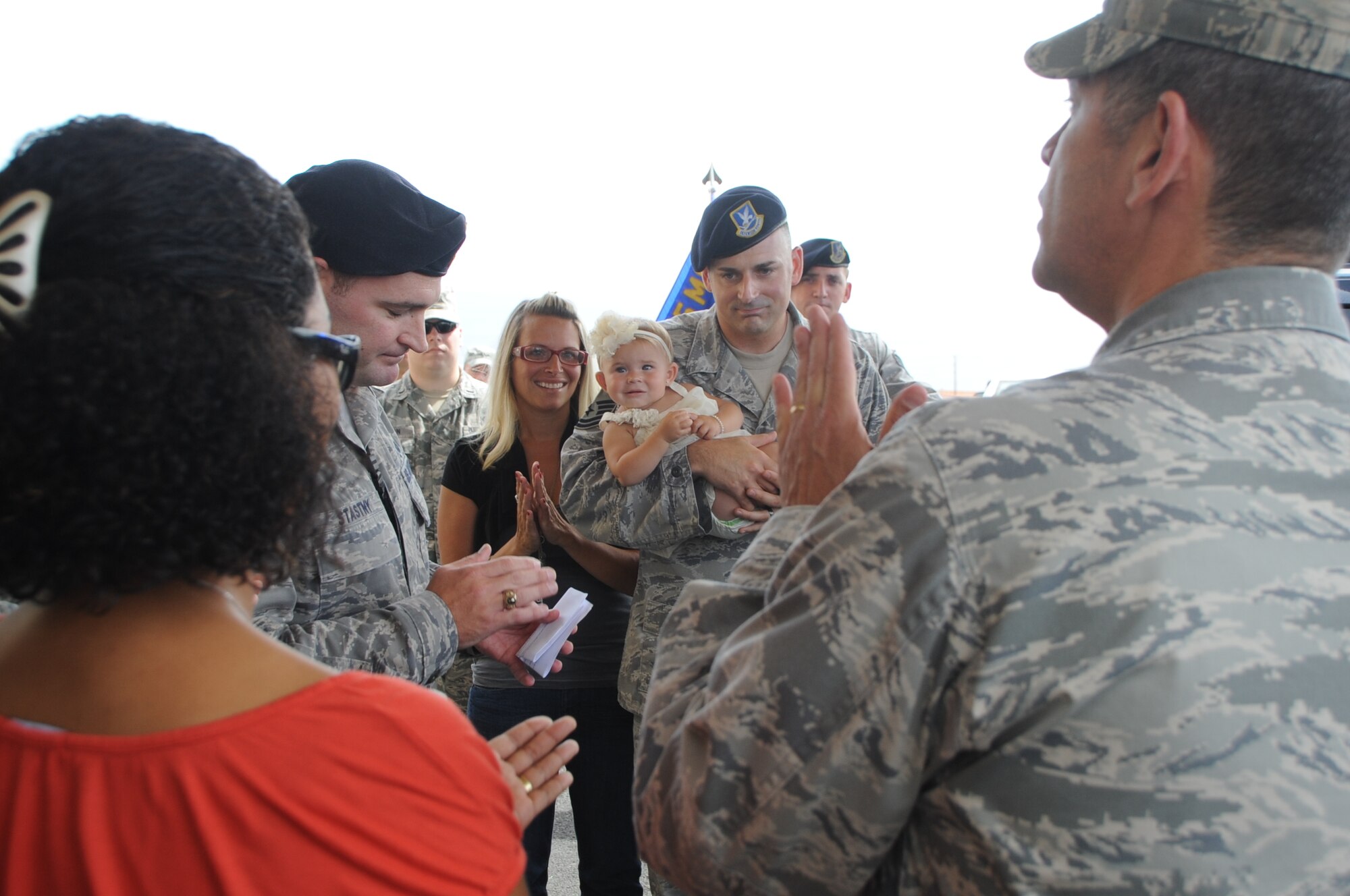 Members of Team Lajes led by Col. Jose Rivera, 65th Air Base Wing commander, greet Master Sgt. Nikki Drago, 65th Security Force Squadron defender, during a “warrior-welcome” held for Sergeant Drago and his family at the Top of the Rock Club’s entrance Aug. 11, 2011.  Sergeant Drago returned to Lajes after a seven-month deployment to the Transit Center at Manas, Kyrgyzstan.  (Photo by Staff Sgt. Olufemi Owolabi)