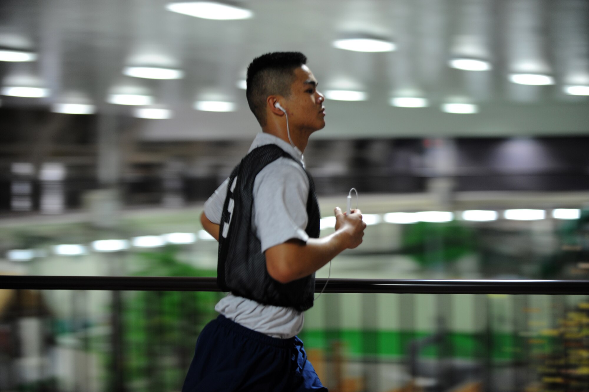 MISAWA AIR BASE, Japan -- Airman 1st Class Jonathan Balgos, 35th Medical Operations Squadron, runs his final lap on the track in the Weasel's Den, completing his physical training test Aug. 11.  The track in the Weasel's Den was built in 2009 to accommodate service members during extreme weather conditions. (U.S. Air Force photo/ Staff Sgt. April Quintanilla)