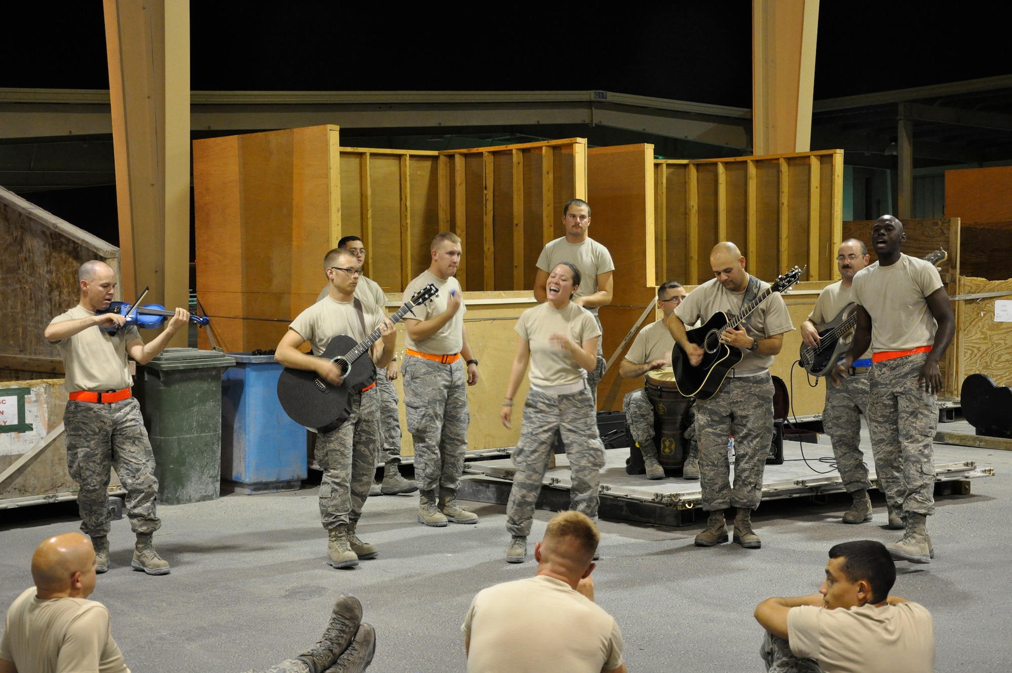 Sidewinder performs a half-hour acoustic set for 8th Expeditionary Air Mobility Squadron Airmen working the night shift at the passenger terminal pallet yard Aug. 8, 2011, in Southwest Asia. Video from that night was uploaded to YouTube, went viral, and now has over 400,000 views. (U.S. Air Force by Staff Sgt Chad Shaver)