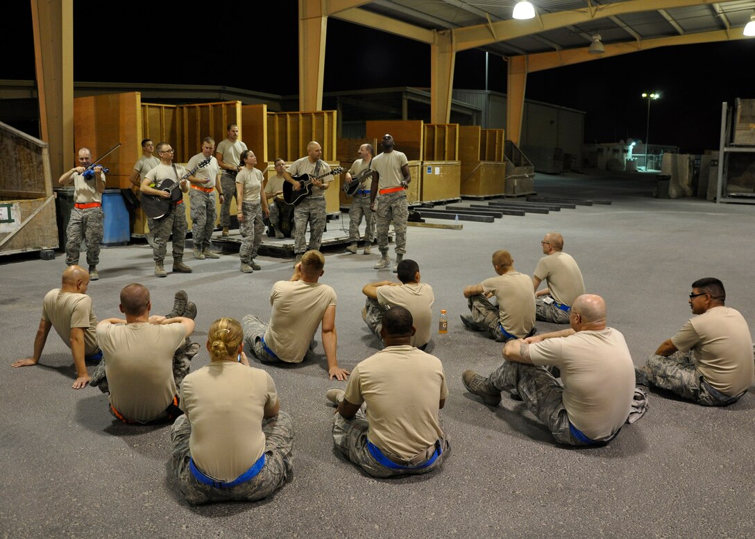 Sidewinder performs a half-hour acoustic set for 8th Expeditionary Air Mobility Squadron Airmen working the night shift at the passenger terminal pallet yard Aug. 8, 2011, in Southwest Asia. Video from that night was uploaded to YouTube, went viral, and now has over 400,000 views. (U.S. Air Force by Staff Sgt Chad Shaver)