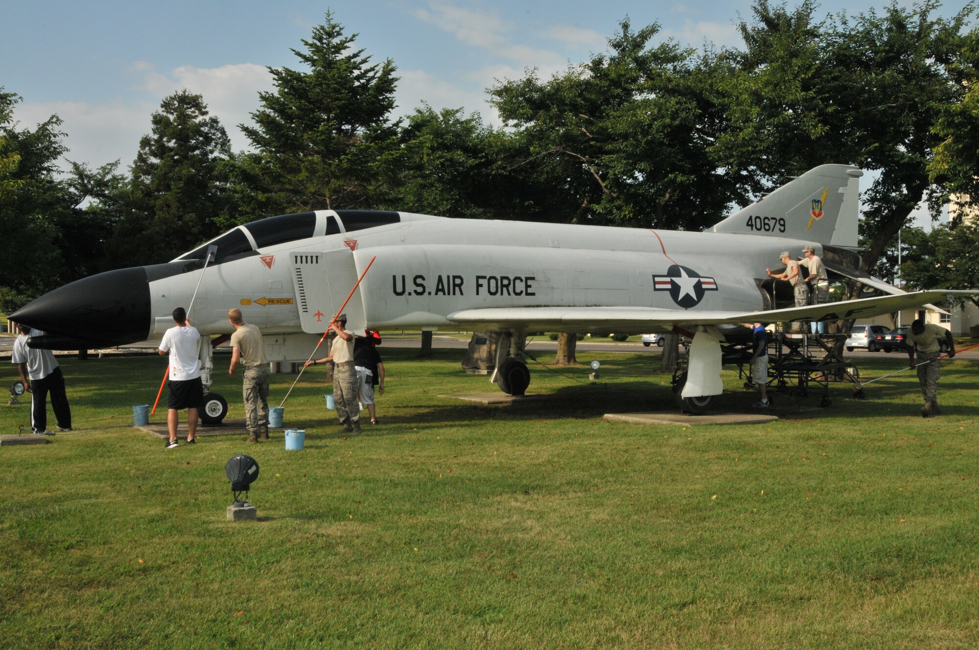 Airmen apply soap, water and elbow grease to a F-4 Phantom at Risner Circle, Misawa Air Base 12 Aug. Members of the 35 Fighter Wing volunteered to clean the two prominent aircraft displays near the wing’s headquarters building. The Phantom earned the nickname “MiG Killers” for their successful engagements against the Russian fighter jets during the Vietnam War. (U.S. Air Force Photo by Captain Darrick B. Lee/released)