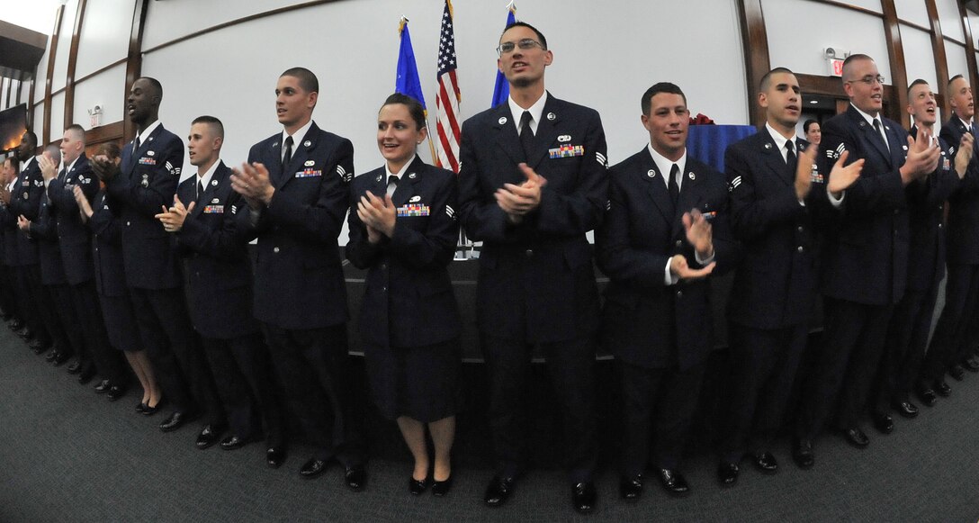 Andersen Air Force Base -- Part of the many Air Force traditions, Airman Leadership School class 11-F, leads attendees in singing the Air Force song during their graduation ceremony at the Sunrise Conference Center here Aug. 11. ALS is one of the many professional military education courses in the Air Force. Airman Leadership school prepares and trains future noncommissioned officers for increased responsibilities. (U.S. Air Force photo by Staff Sgt. Alexandre Montes)