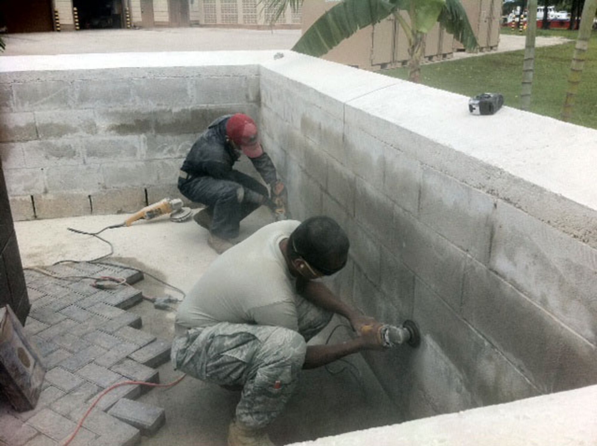 Members of the 554 Red Horse Squadron here work in conjunction with Explosive Ordnance Disposal Mobil Unit 5, to create a memorial in honor of Navy EOD Technician 1st Class Louis Souffront. Petty Officer Souffront was killed by an improvised explosive device during Operation Iraqi Freedom in February of 2008. (U.S. Air Force Courtesy Photo)