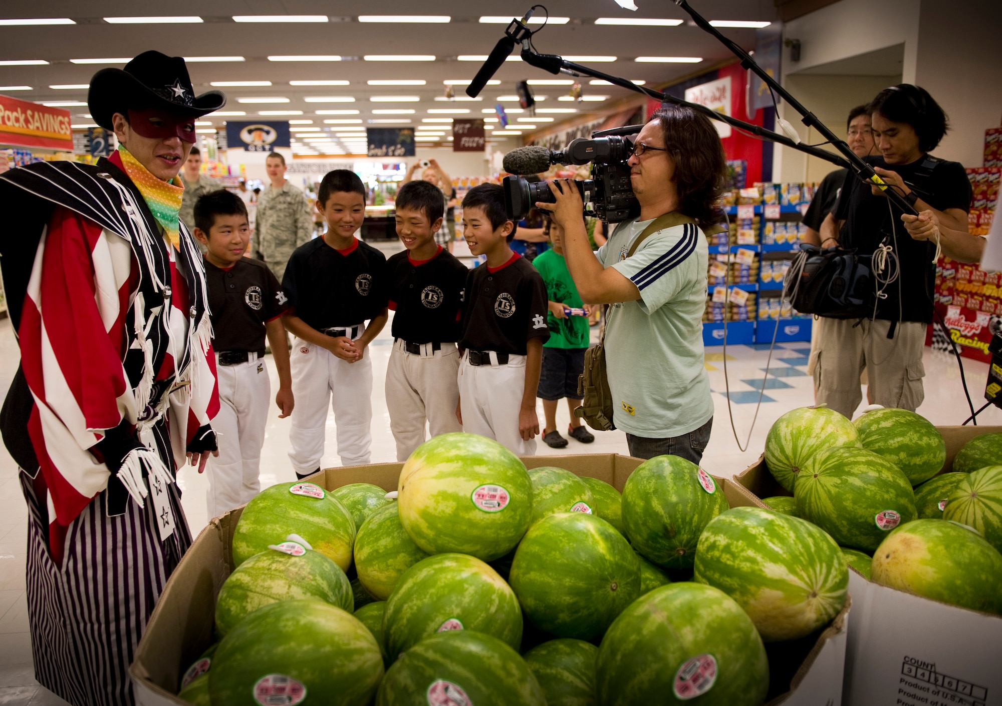YOKOTA AIR BASE, Japan -- The Nippon Hoso Kyokai international broadcasting company visited the Commissary at Yokota Air Base, Japan, to tape an episode of the Pre-Eigo, or Pre-Basic English television program, Aug. 9, 2011. The premise of the episode was to show English words of common supermarket items to approximately 15 Japanese speaking children having them looking through the commissary to find them. The show's host and the children are looking in the produce section for their first product. (U.S. Air Force photo/Staff Sgt. Stacy Moless)