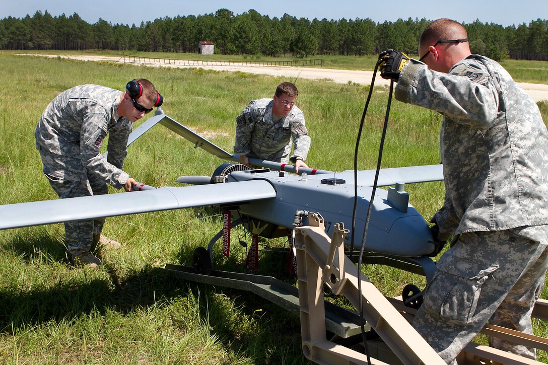 Army soldiers mount a Shadow 200 unmanned aerial vehicle onto its launching catapult for a training flight on Fort Bragg, N.C., Aug. 10, 2011. The catapult launches the 400-pound UAV in fewer than 40 feet.