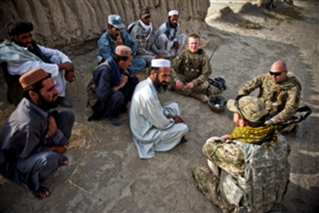 U.S. Army 1st Lt. Stuart Barnes and 1st Lt. Shane Smith speak with Kala Hagi Azgar village elders about potential problems in the village and the possible help they could provide in Sharana, Afghanistan, Aug. 10, 2011. Village elders said they were concerned about having only one working well for their entire village. Barnes is assigned to 366th Headquarters Company and Smith is assigned to the Paktika Provincial Reconstruction Team.