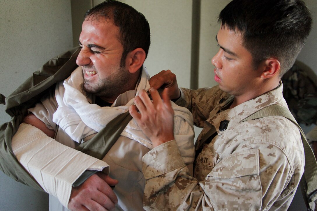 Petty Officer 3rd Class Jessie C. Alday applies a bandage to a simulated casualty during Combat Logistics Battalion 11's humanitarian assistance training here Aug. 12. The battalion provides logistics and services to the 11th Marine Expeditionary Unit, scheduled to deploy this fall. Alday, a corpsman, is a 26-year-old from San Diego.