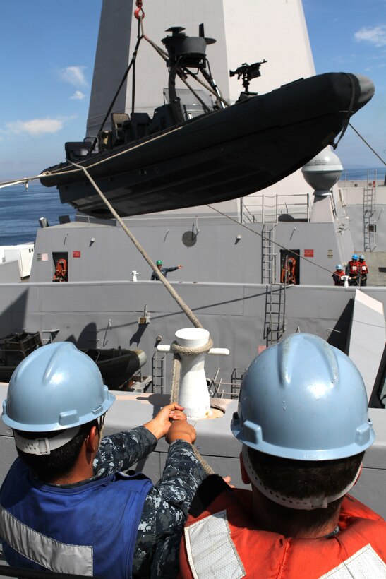 Sailors aboard USS New Orleans prepare a Navy rigid-hulled inflatable boat Aug. 12 to carry maritime raid force members of the 11th Marine Expeditionary Unit. The force’s assault element practiced boarding vessels from the ocean’s surface miles from Southern California during the unit's first sea-based exercise since becoming a complete Marine air ground task force in May.