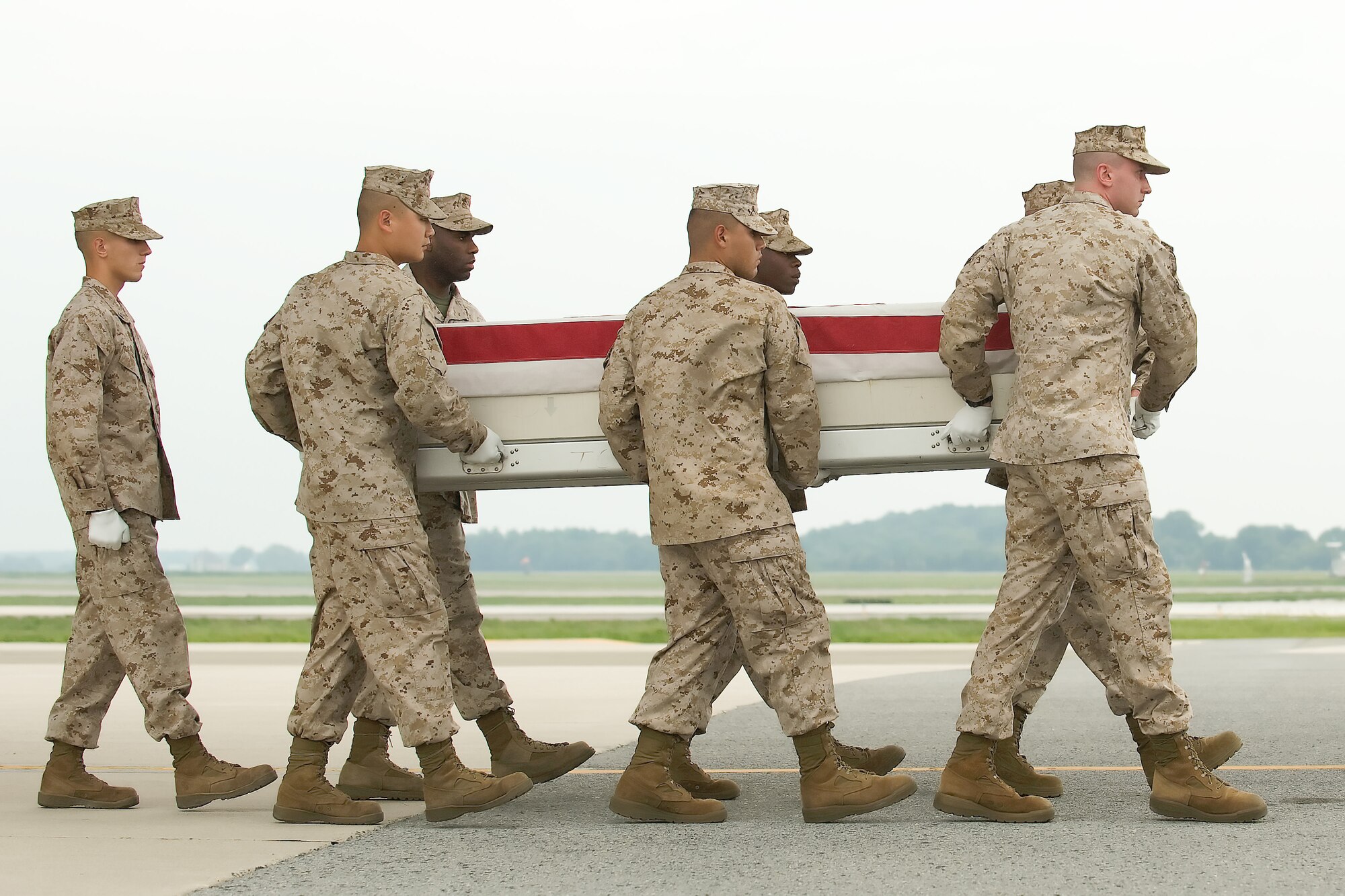A U.S. Marine Corps carry team transfers the remains of Marine Cpl. Nicholas S. Ott, of Manchester, N.J., at Dover Air Force Base, Del., Aug. 13, 2011. Ott was assigned to the 1st Battalion, 3rd Marine Regiment, 3rd Marine Division, III Marine Expeditionary Force, Kaneohe Bay, Hawaii. (U.S. Air Force photo/Steve Kotecki)