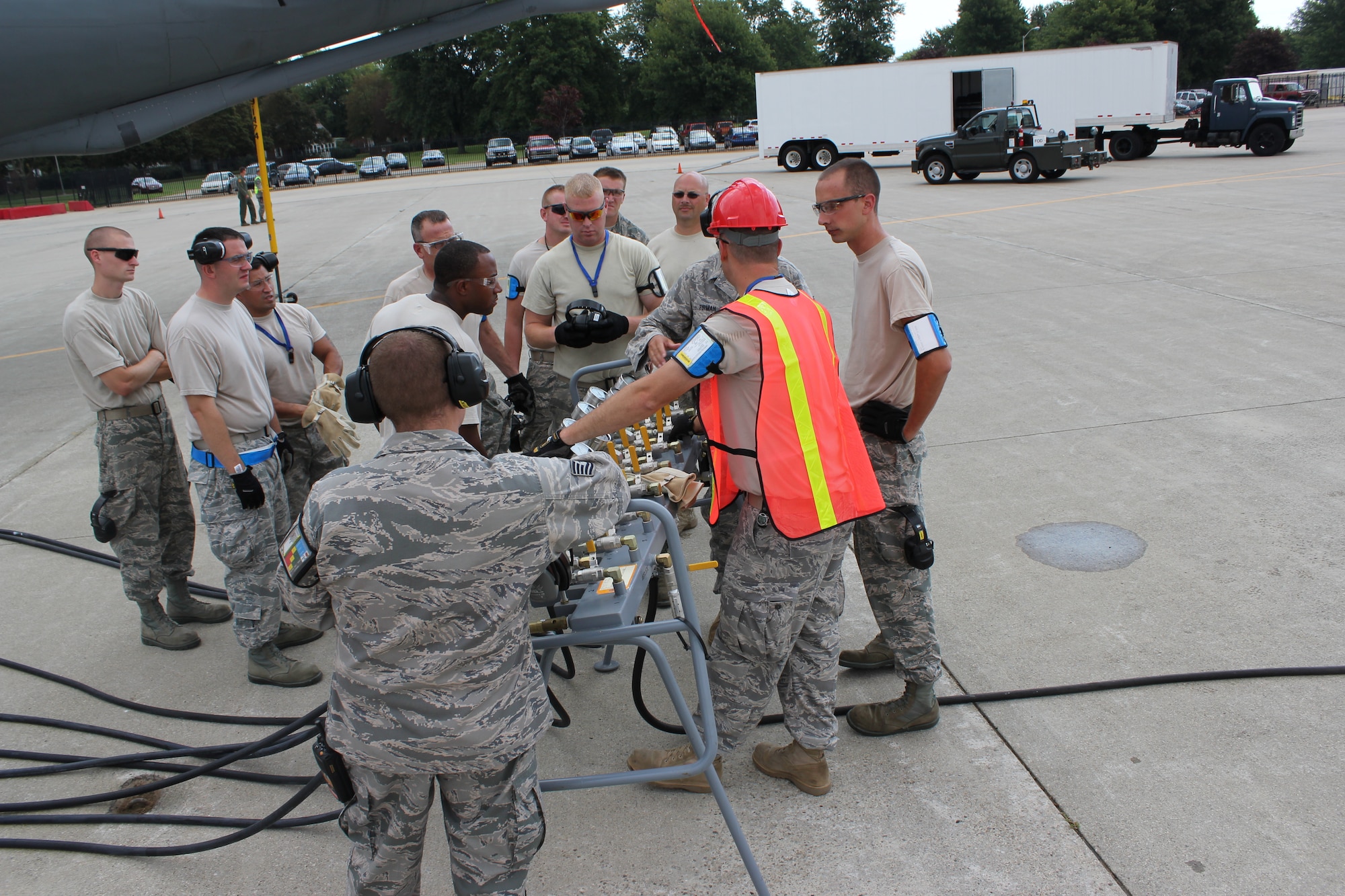 Airmen from the 191st Maintenance Squadron, huddle together to have an initial debrief after a training exercise at Selfridge Air National Guard Base, Mich., Aug. 13, 2011. The 191st MXS performed an exercise in which they simulated a KC-135 had damaged nose gear and a crane was needed to move the aircraft to a safe location for repair. After such exercises, Airmen gather for both formal and informal debriefings, to review the operation and to learn how they could improve in the future. (USAF photo by TSgt. Dan Heaton)