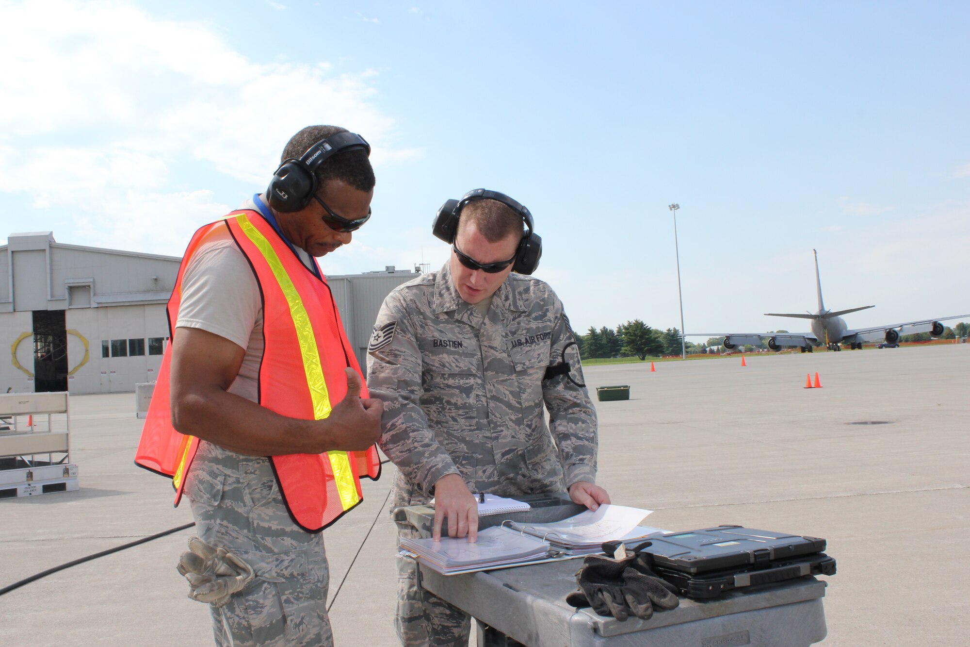TSgt. Louis Jones and TSgt. Richard Bastien, 191st Maintenance Squadron, examine a technical order during a training exercise at Selfridge Air National Guard Base, Mich., Aug. 13, 2011. The 191st MXS performed an exercise in which they simulated a KC-135 Stratotanker had damaged nose gear and a crane was needed to move the aircraft to a safe location for repair. All aircraft maintenance operations are detailed in technical orders, which are used by Airmen to ensure that aircraft are properly prepared for flight. (USAF photo by TSgt. Dan Heaton)