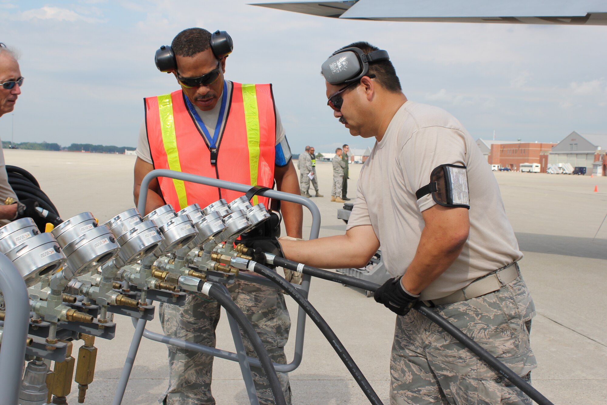 TSgt. Louis Jones and SSgt. Allen Jauw, 191st Maintenance Squadron, hook up hoses to an air regulator during a training exercise at Selfridge Air National Guard Base, Mich., Aug. 13, 20011. The 191st MXS performed an exercise in which they simulated a KC-135 Stratotanker had damaged nose gear and a crane was needed to move the aircraft to a safe location for repair. The air system was used to fill a series of bladders that could cushion the tail of aircraft while the nose of the aircraft was lifted by a crane. (USAF photo by TSgt. Dan Heaton)